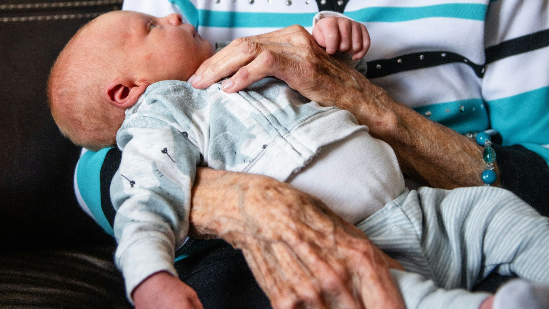 an older woman holding a baby