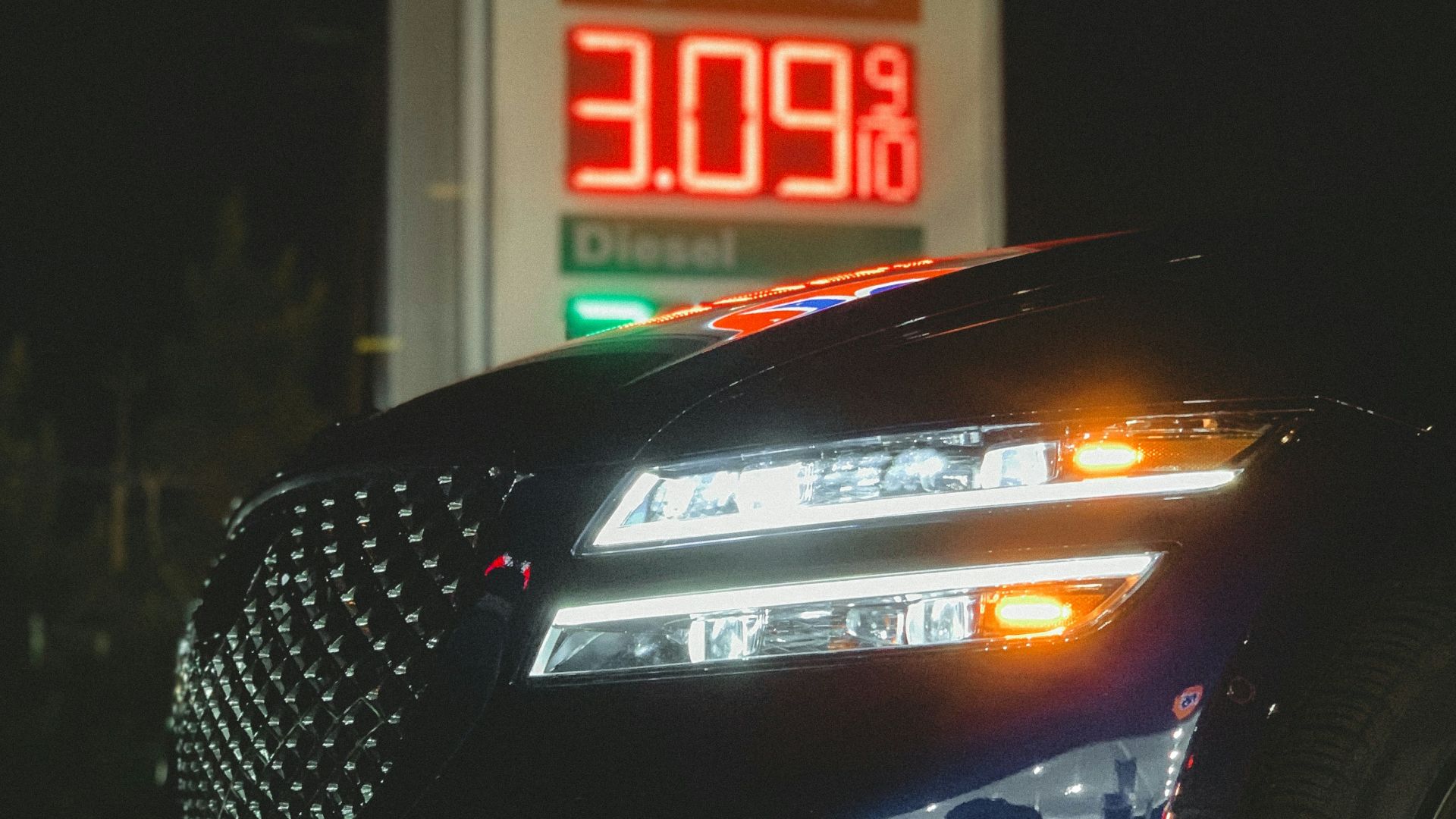 a car parked in front of a gas station