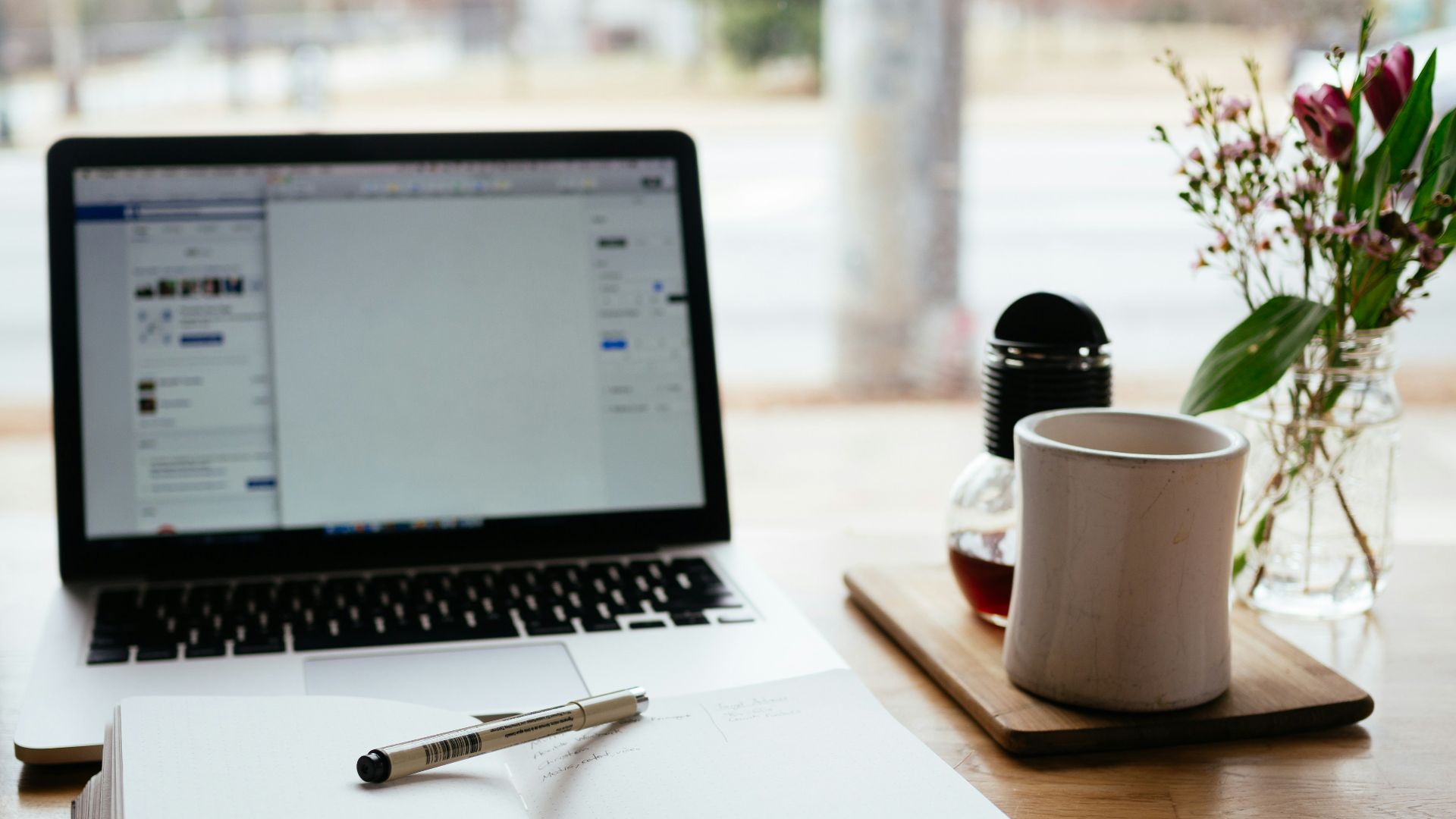 MacBook Pro near white open book