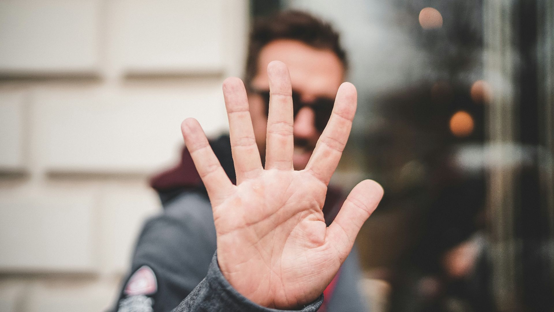 man raising right hand