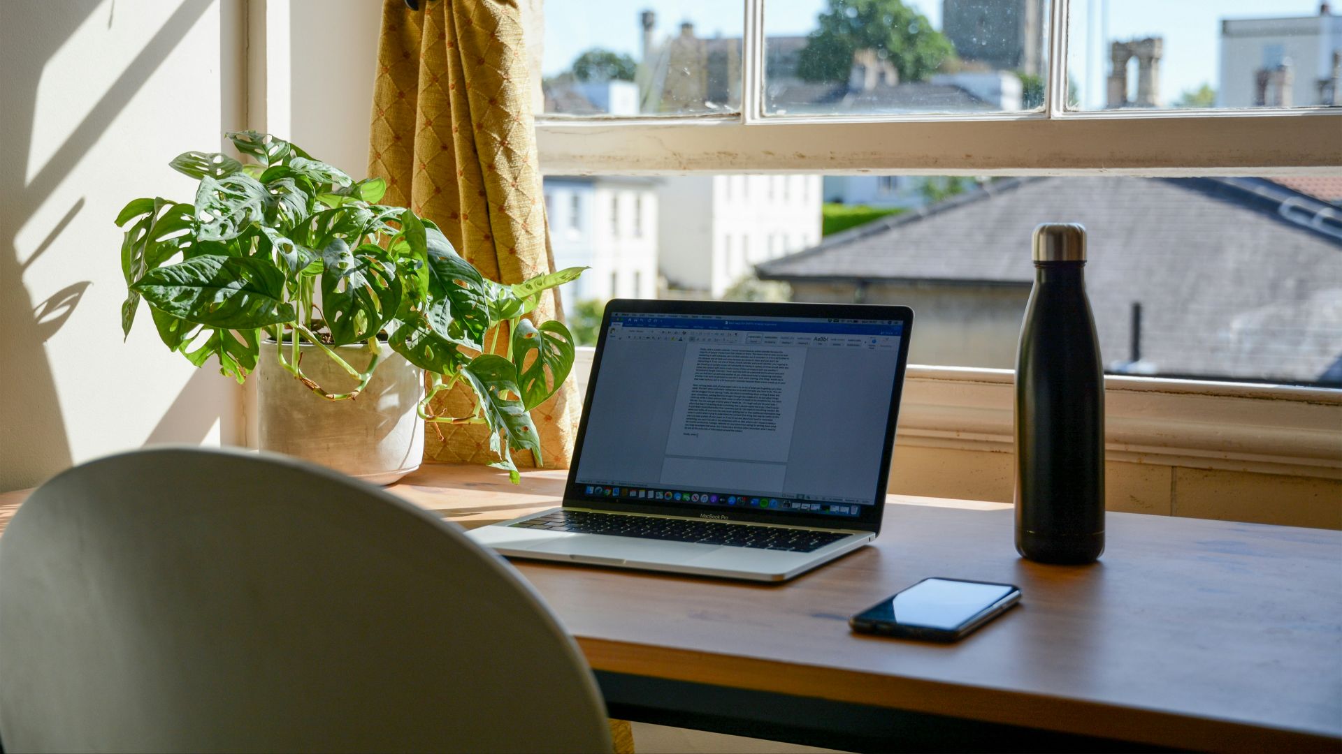 macbook pro on brown wooden table
