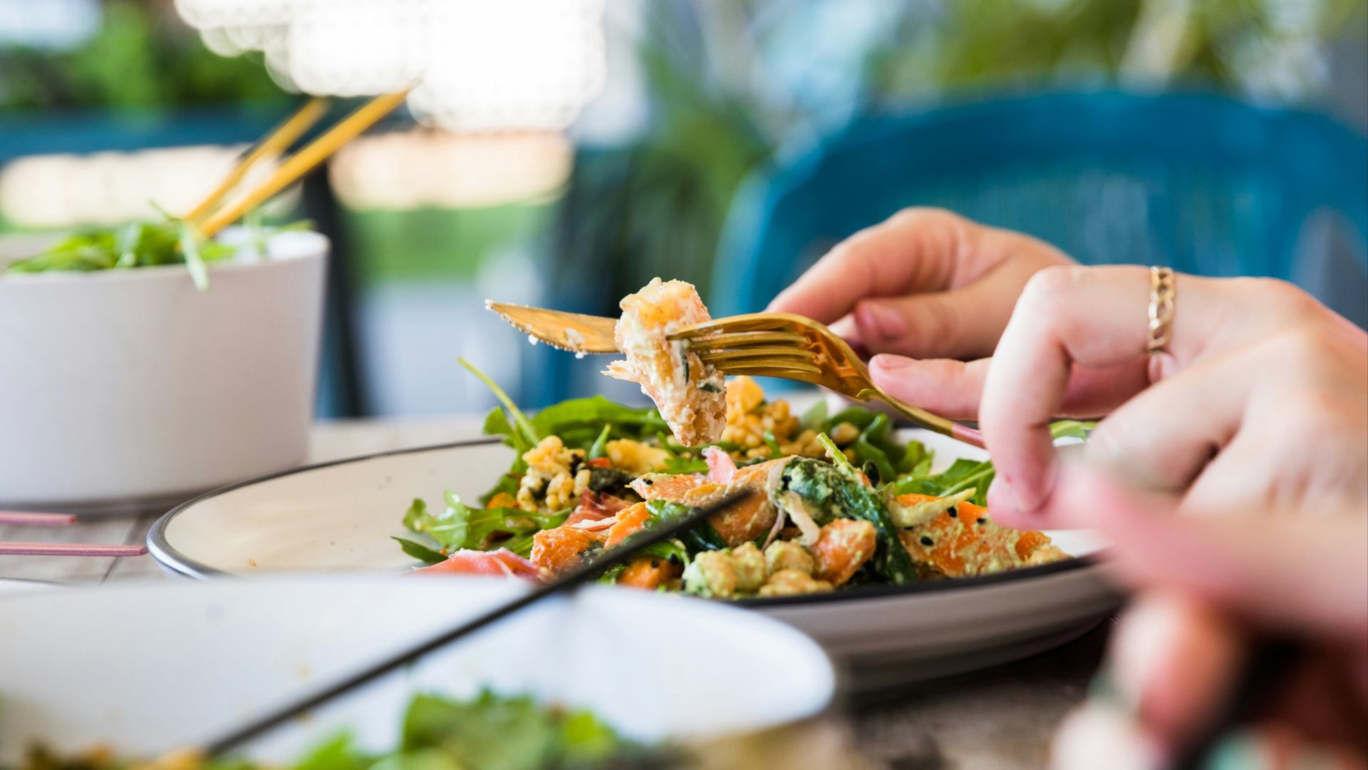person holding brown and green vegetable dish