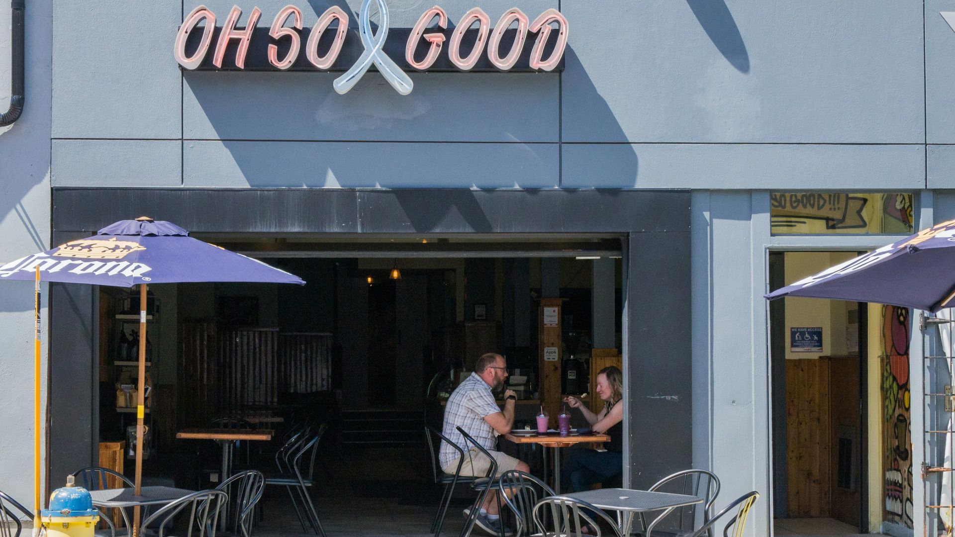 man and woman sitting on chair in front of table