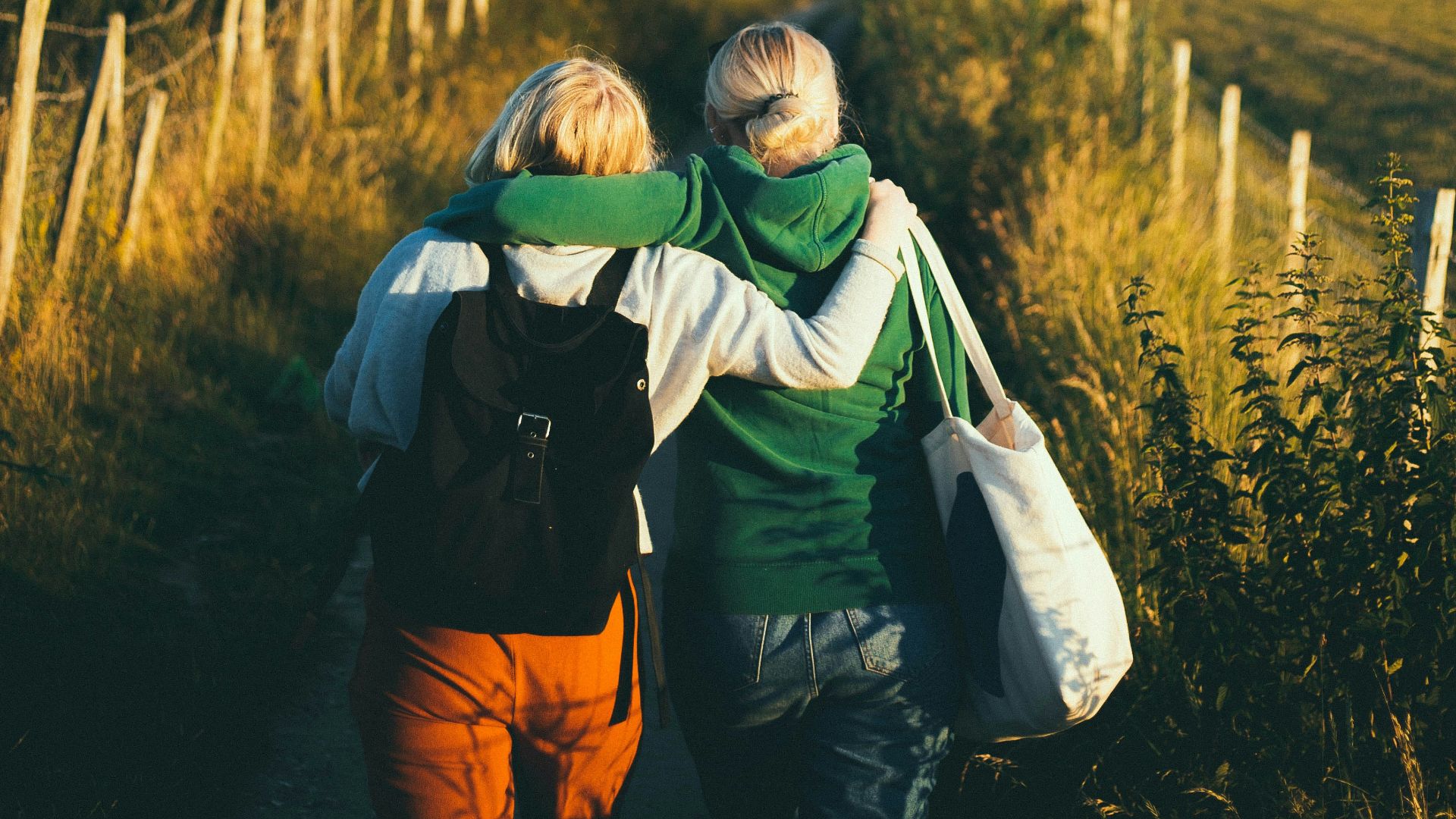 two women walking together outdoor during daytime