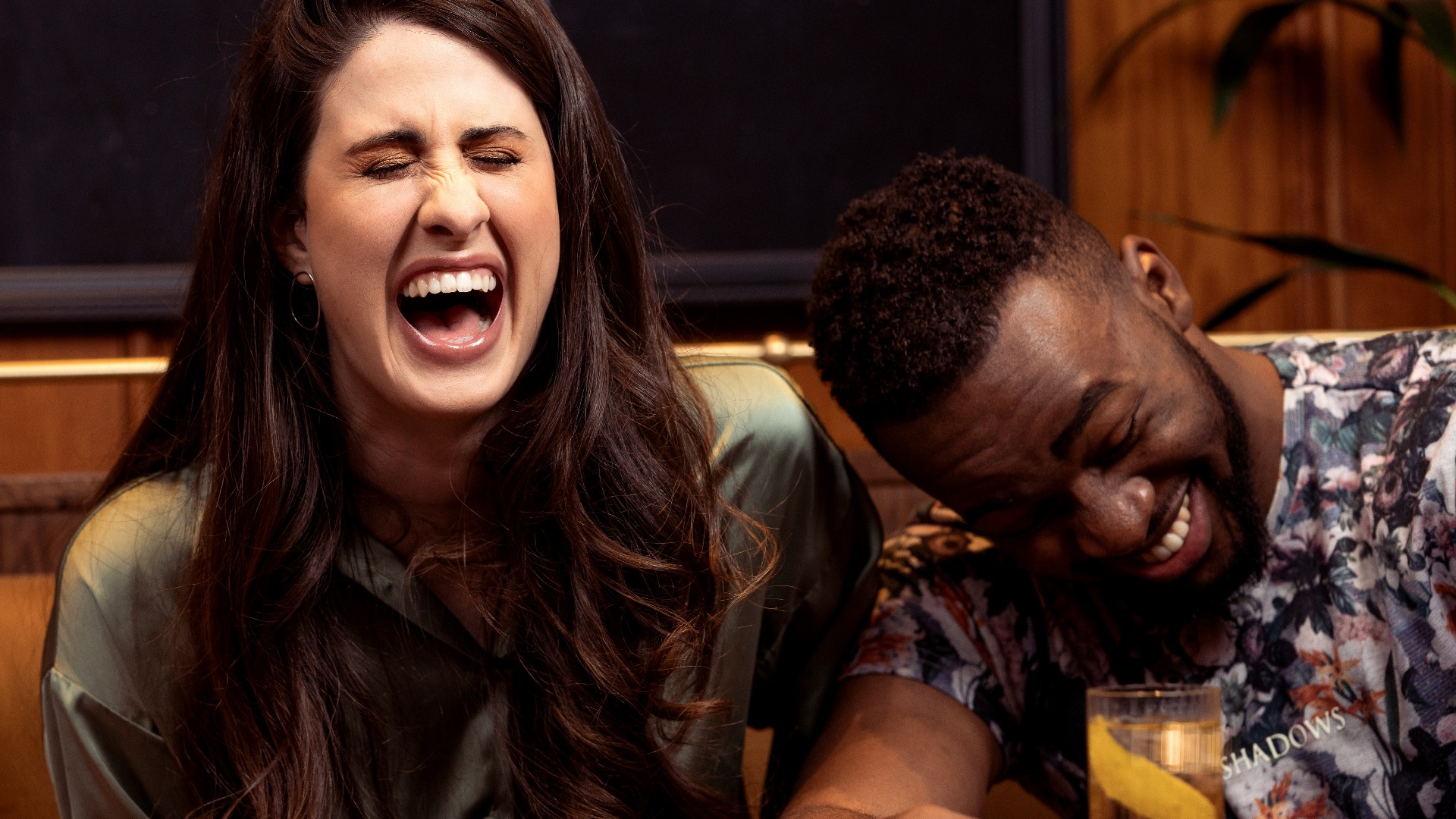 a group of people sitting around a table with drinks
