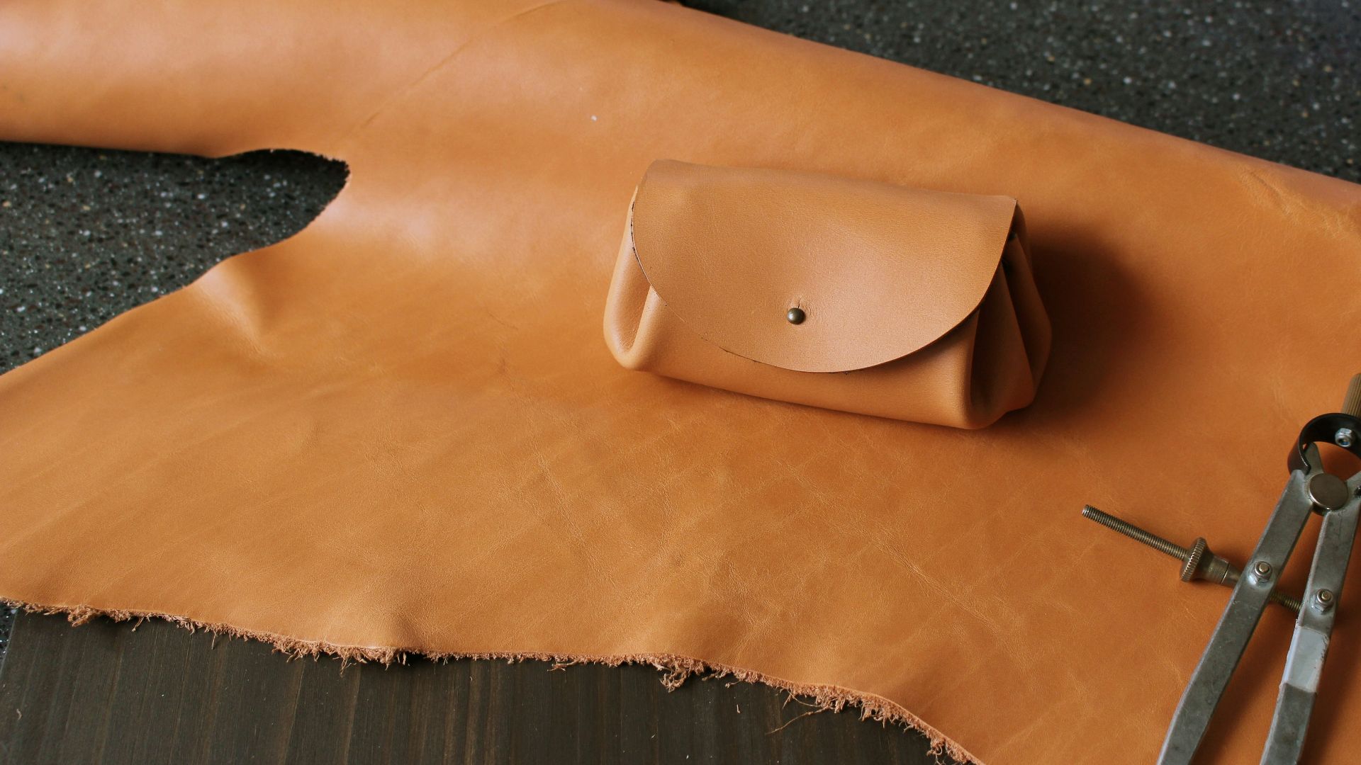 brown leather pouch on textile