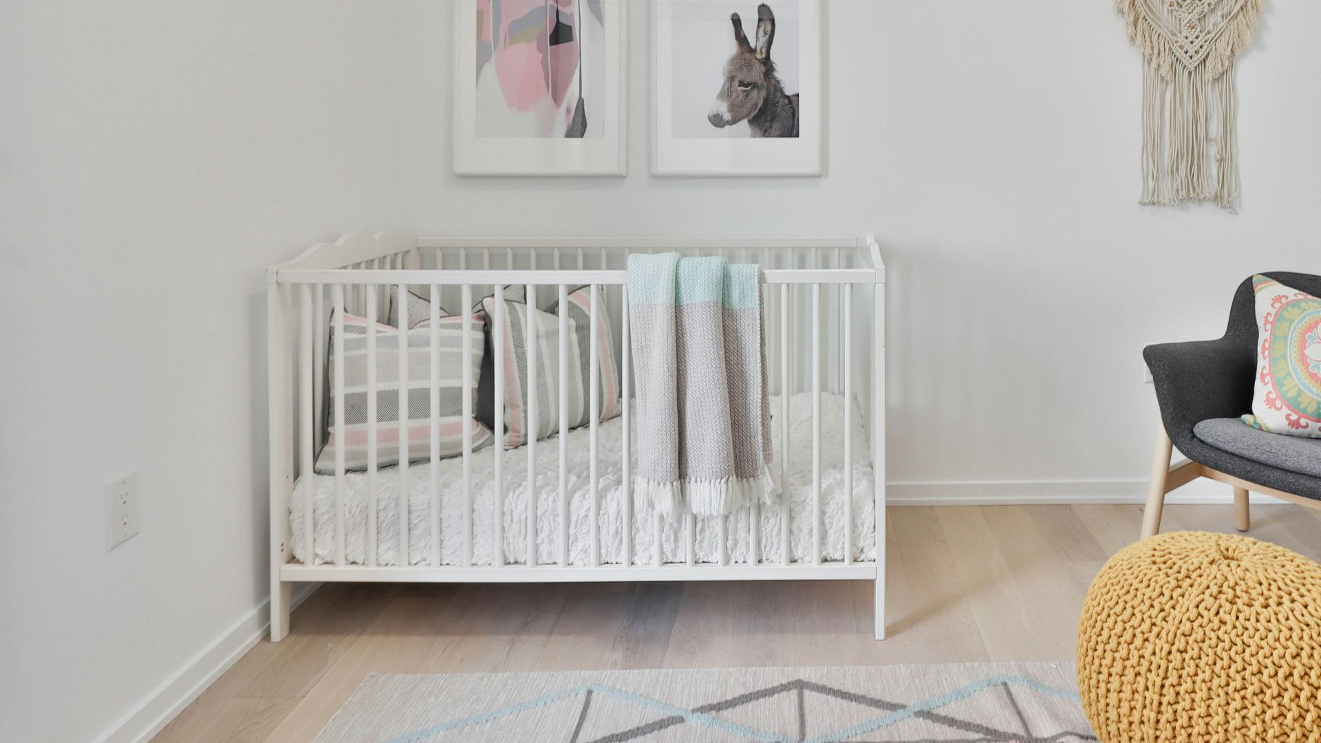 a bedroom with a bed and a chair in a room