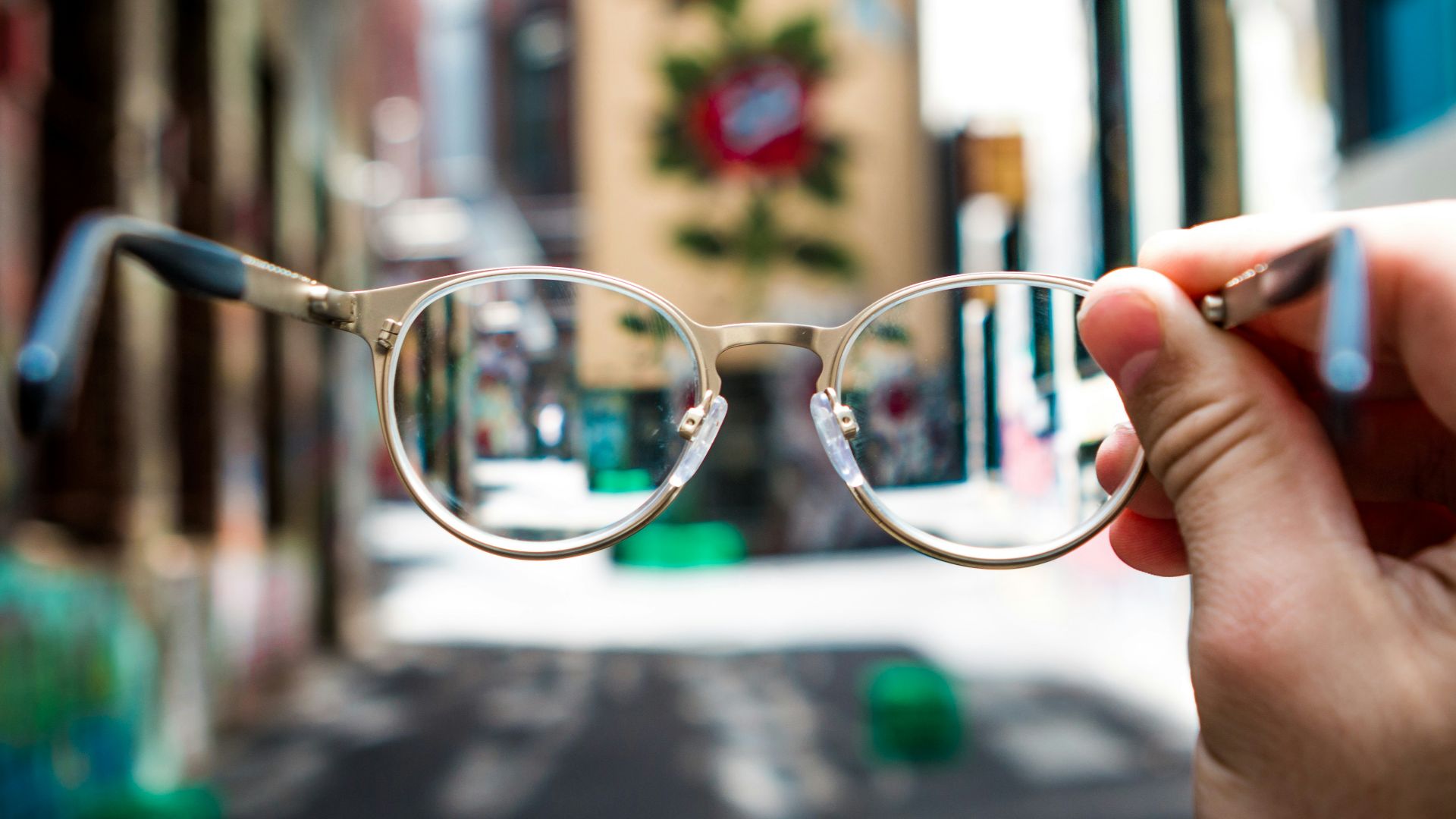 person holding eyeglasses