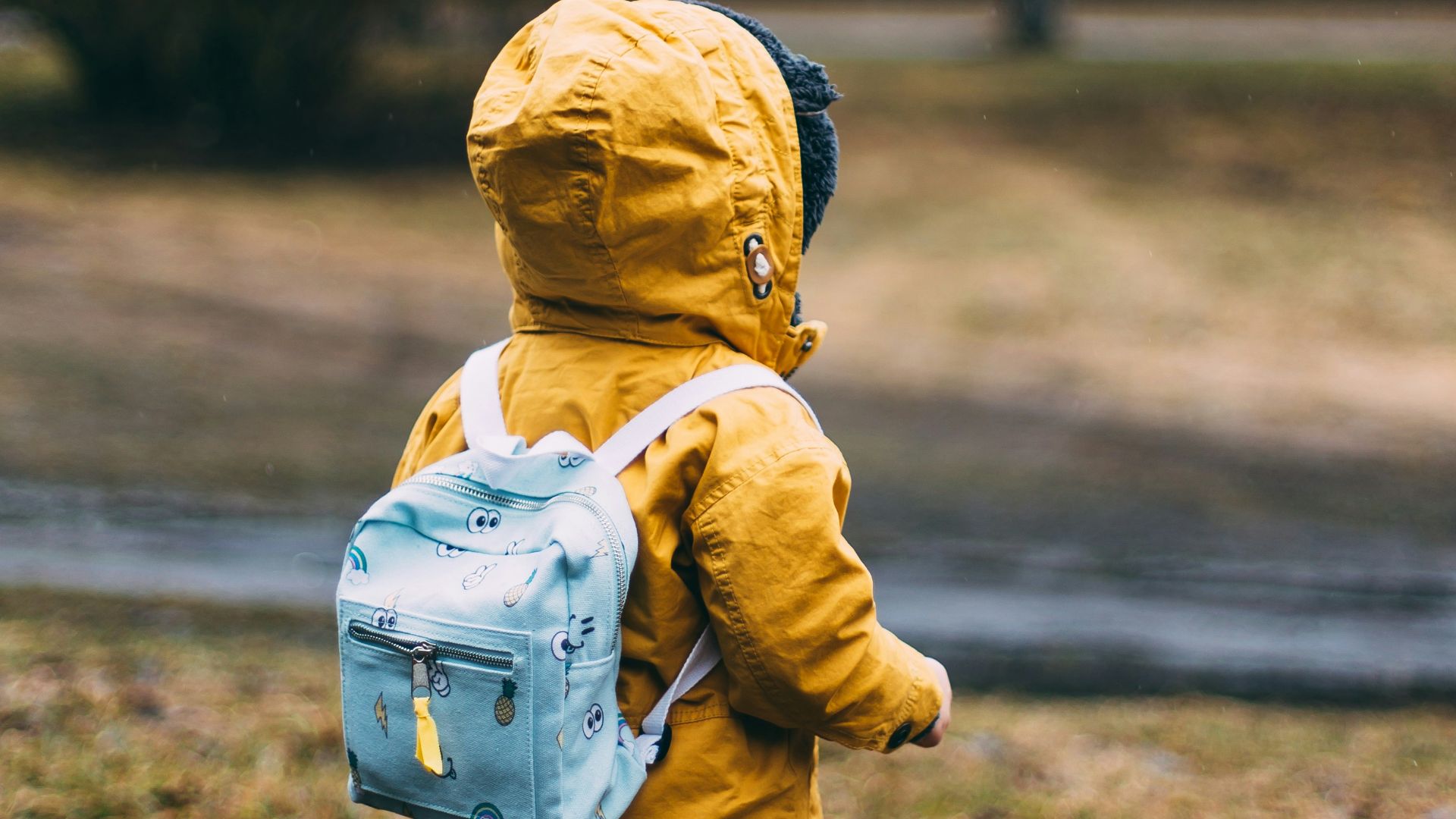 shallow focus photo of toddler walking near river