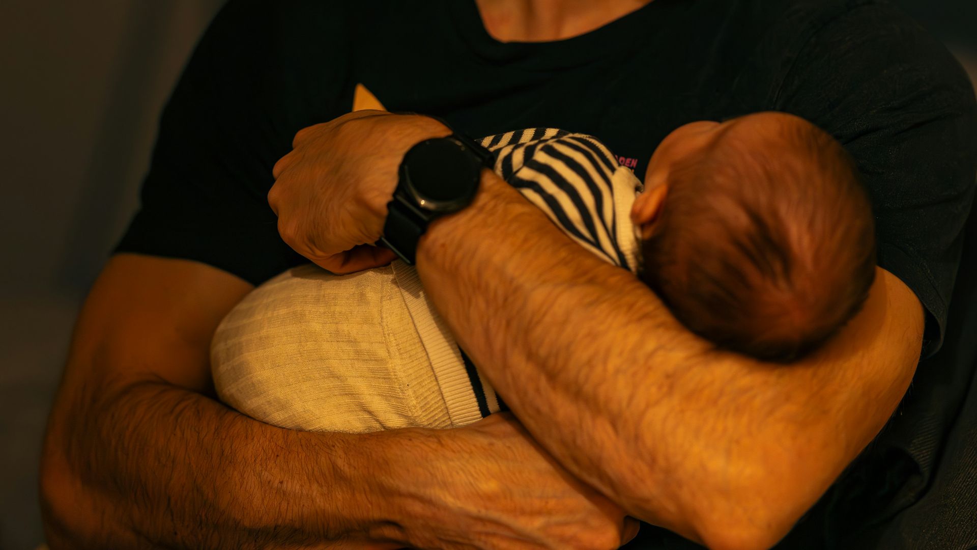 A man holding a baby in his arms