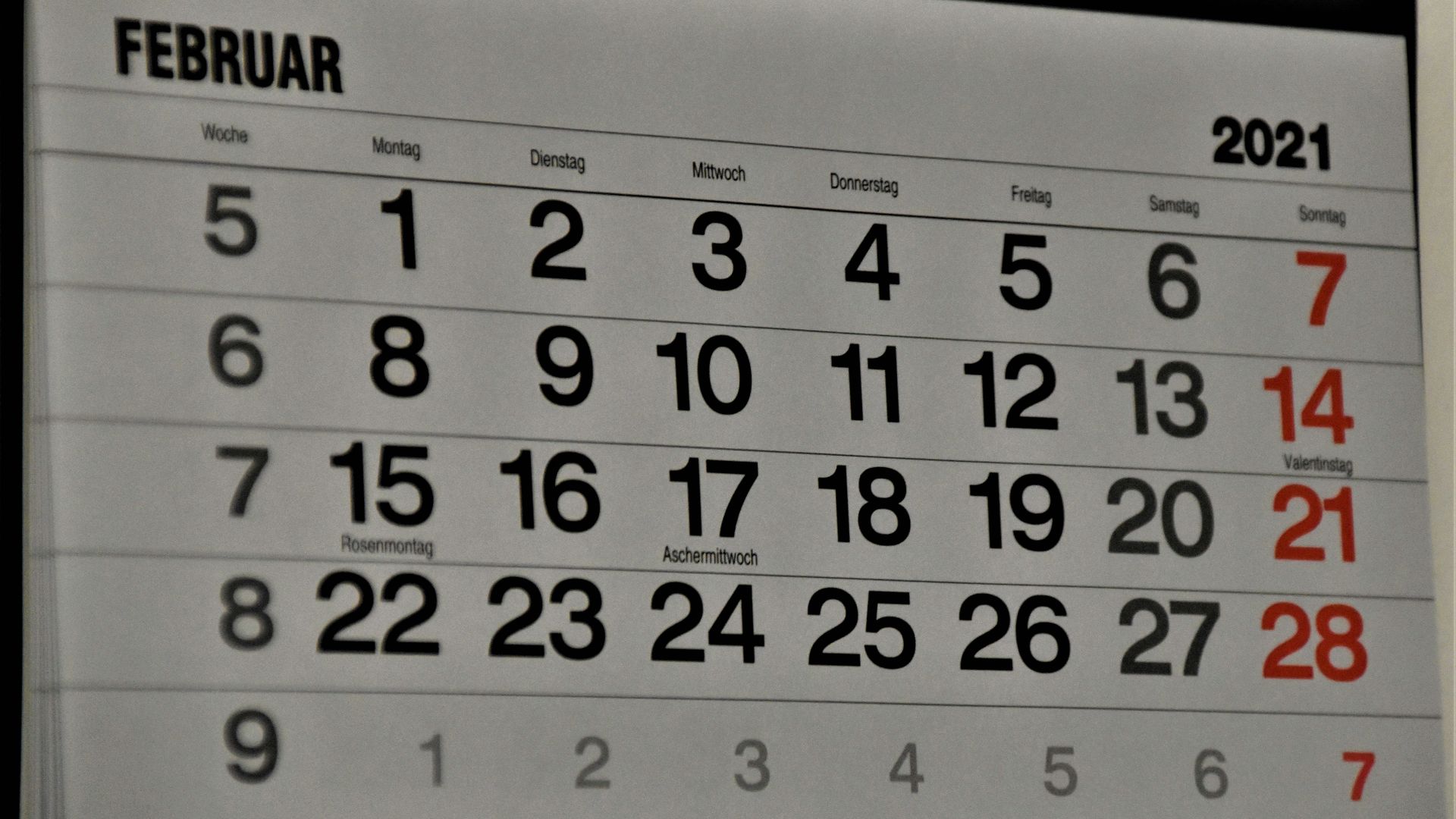 black and white calendar on white wall