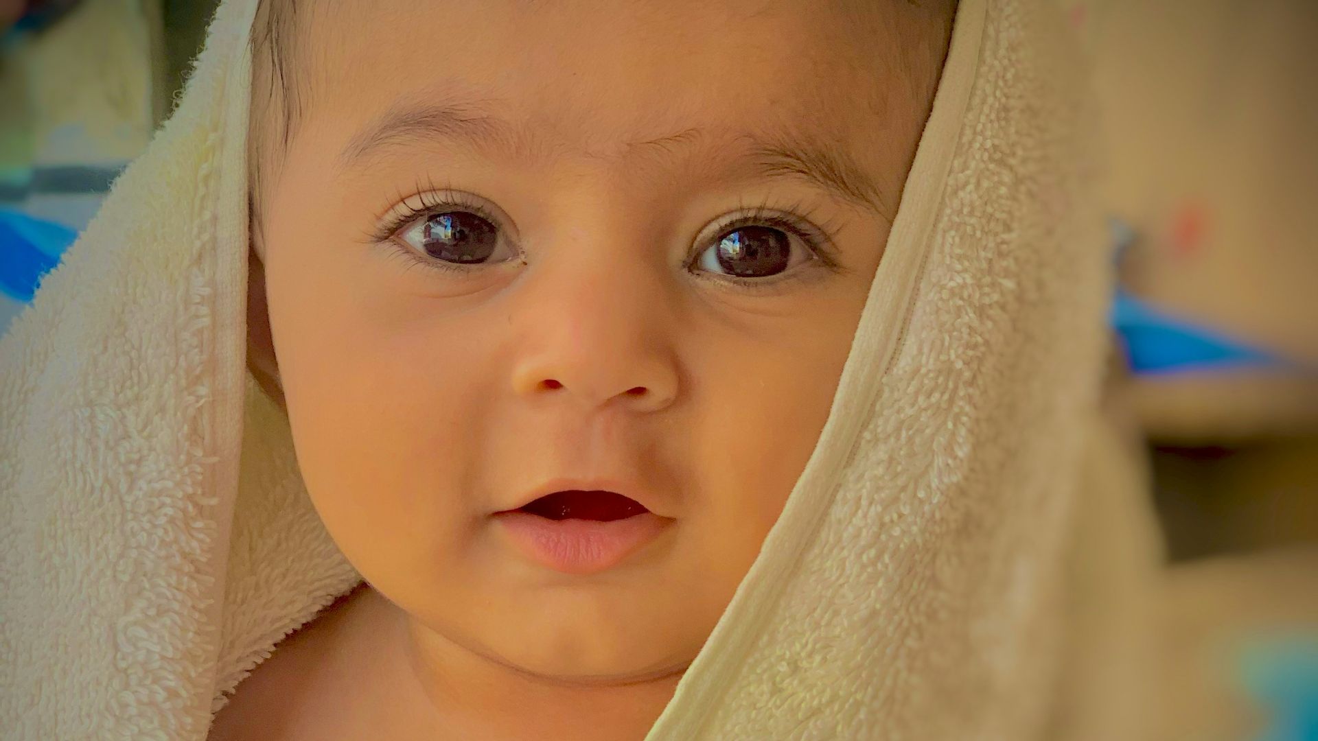 a baby with a towel around her head