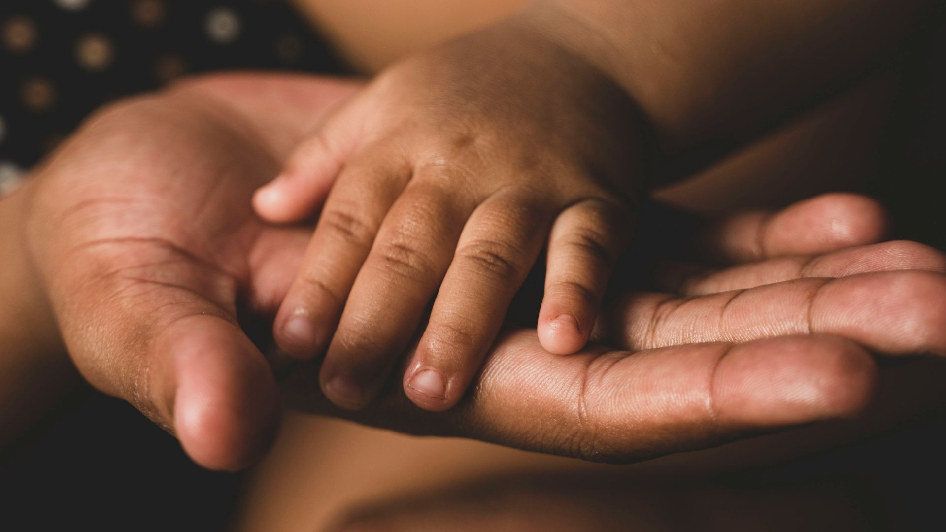 a close up of a person holding their hands together