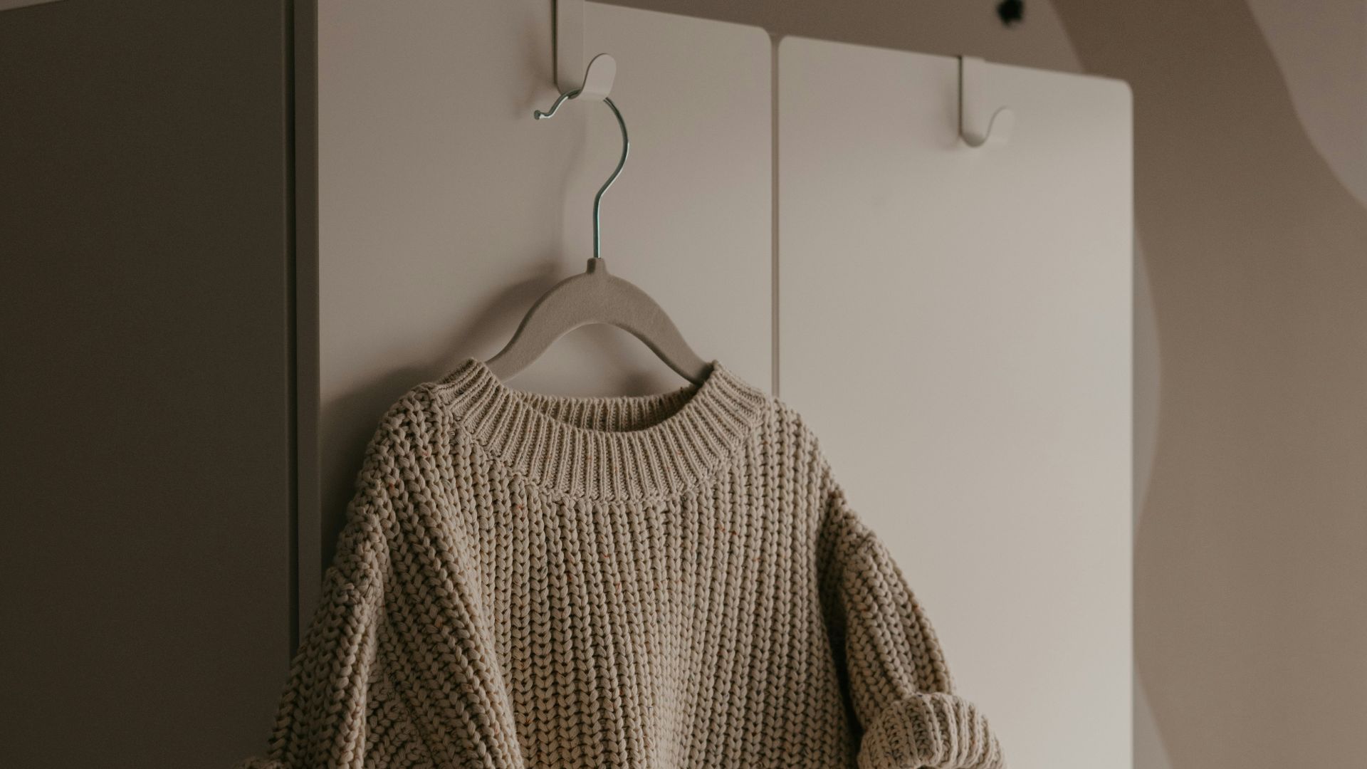 a sweater hanging on a hook in a room