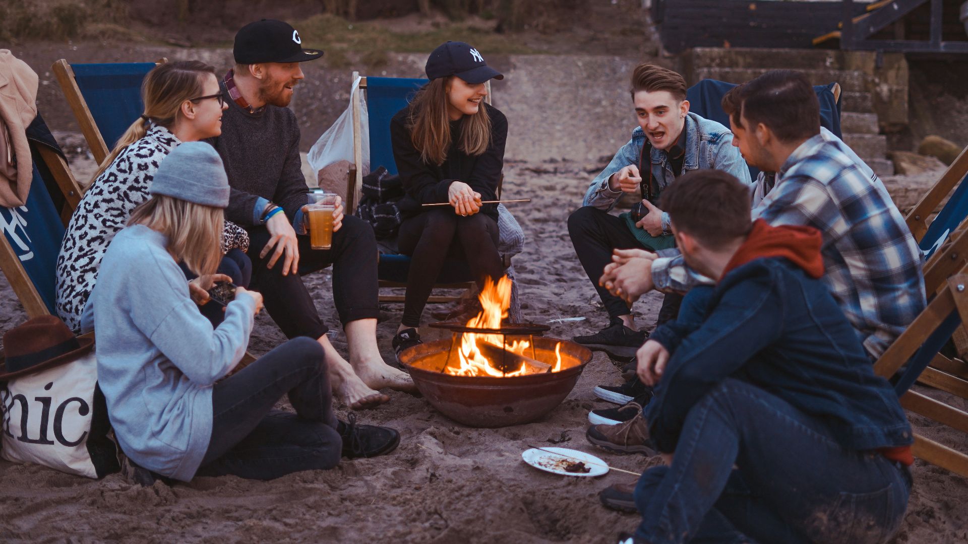 group of people sitting on front firepit