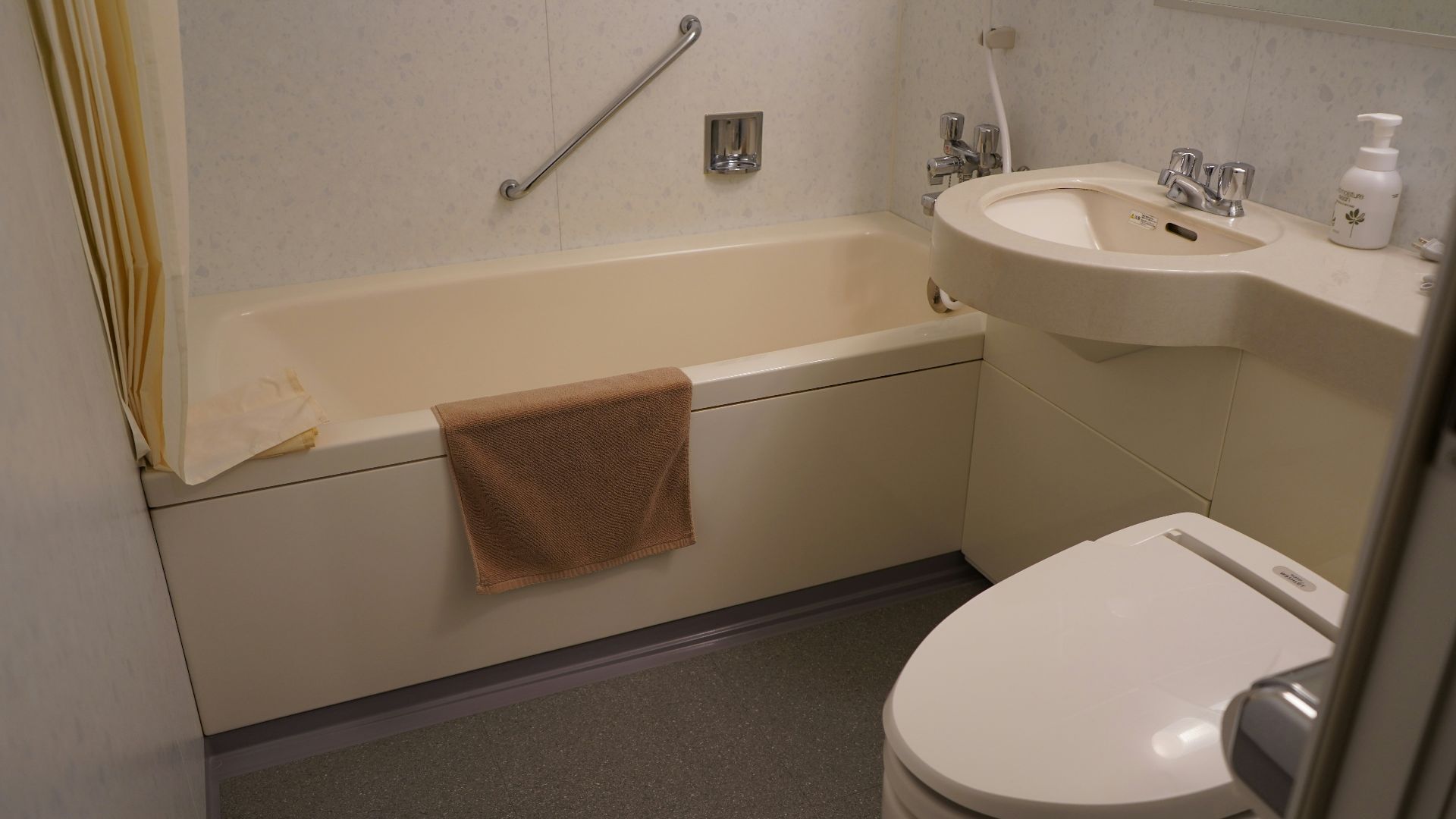 a bathroom with a tub sink and toilet