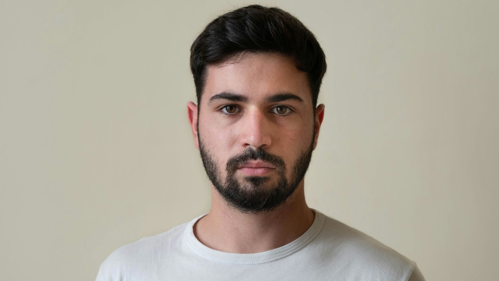 a man with a beard wearing a white shirt