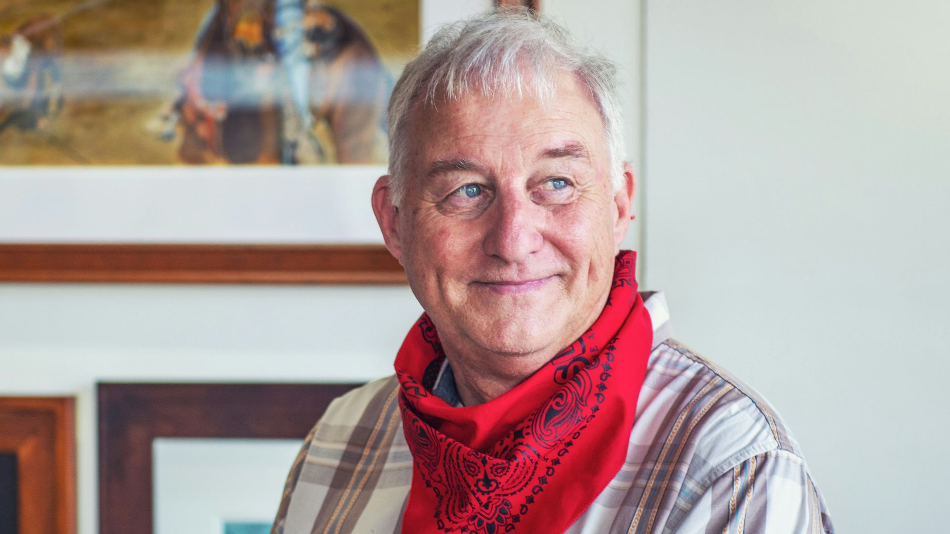 man in gray and white plaid dress shirt and red scarf
