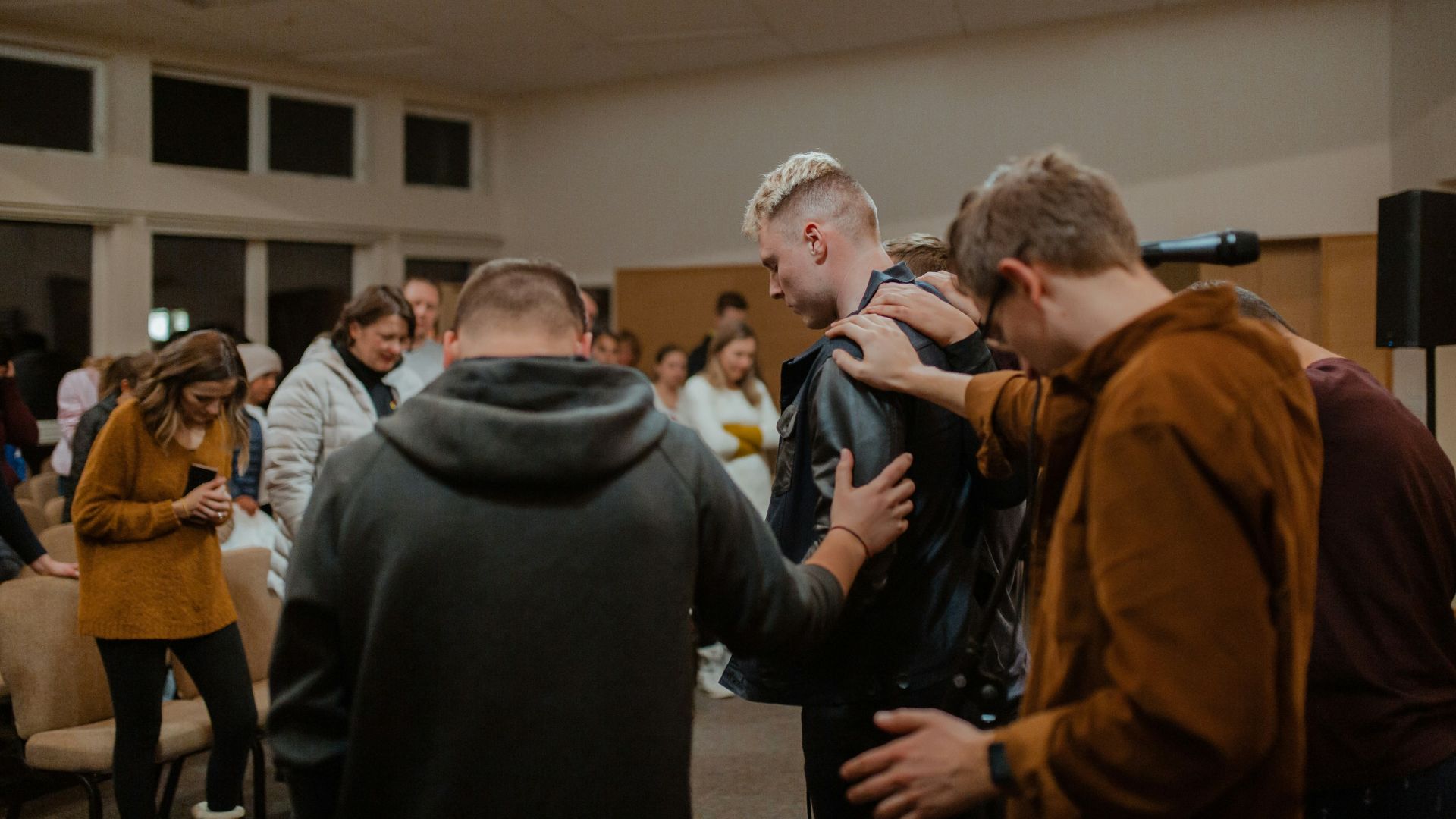 people in black and brown jackets standing in front of people