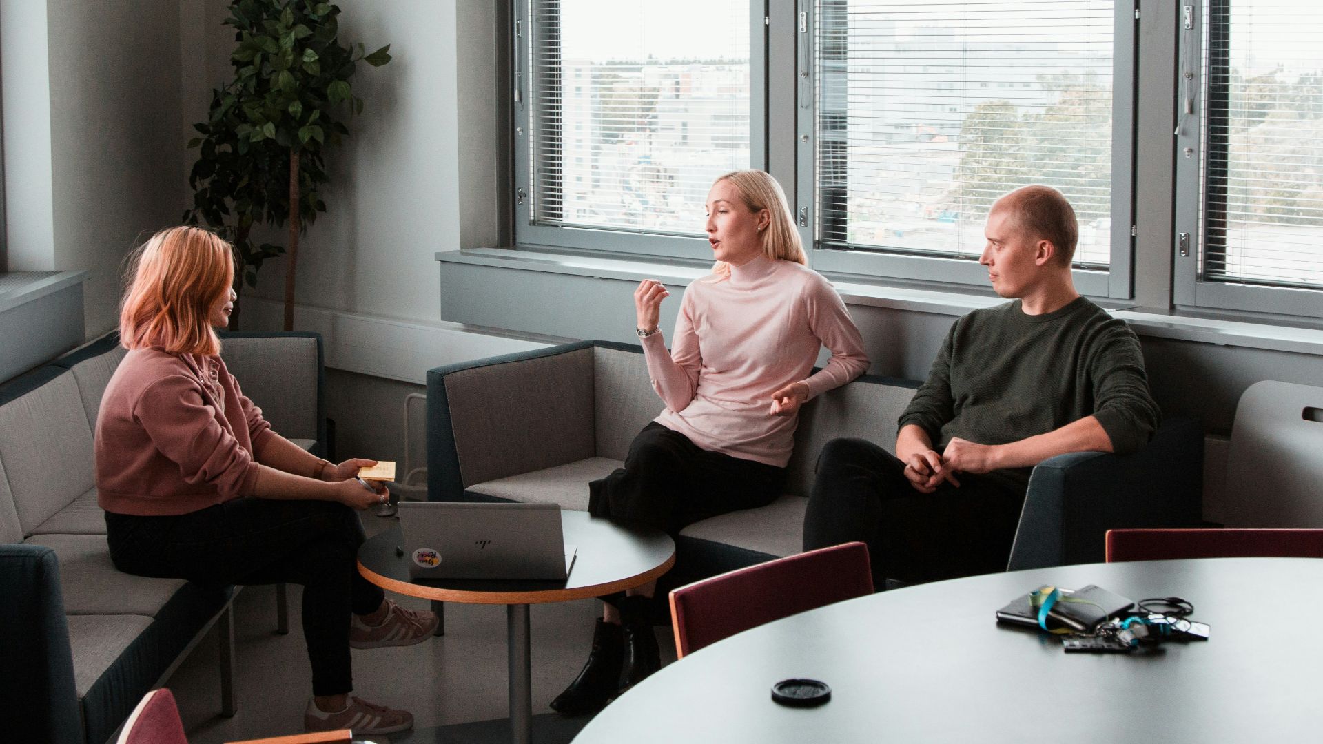 2 women sitting on black sofa
