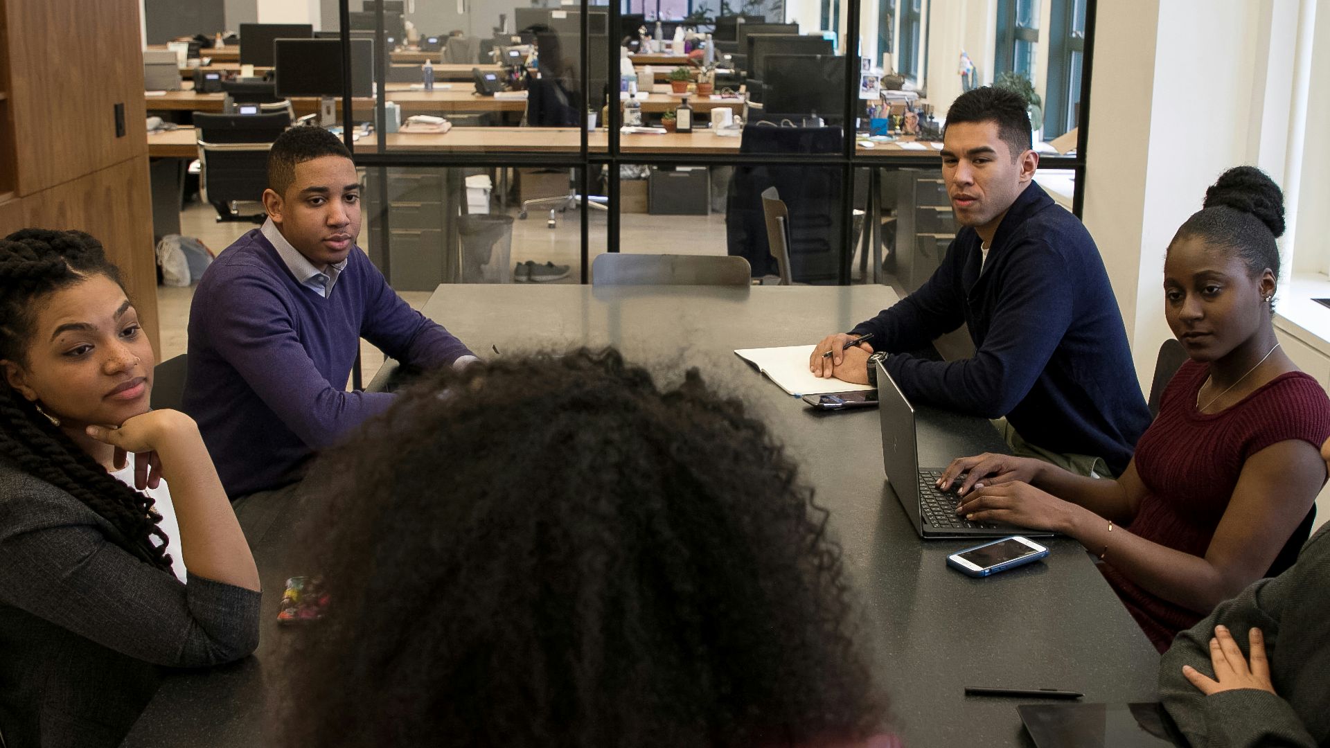 a group of people sitting around a table