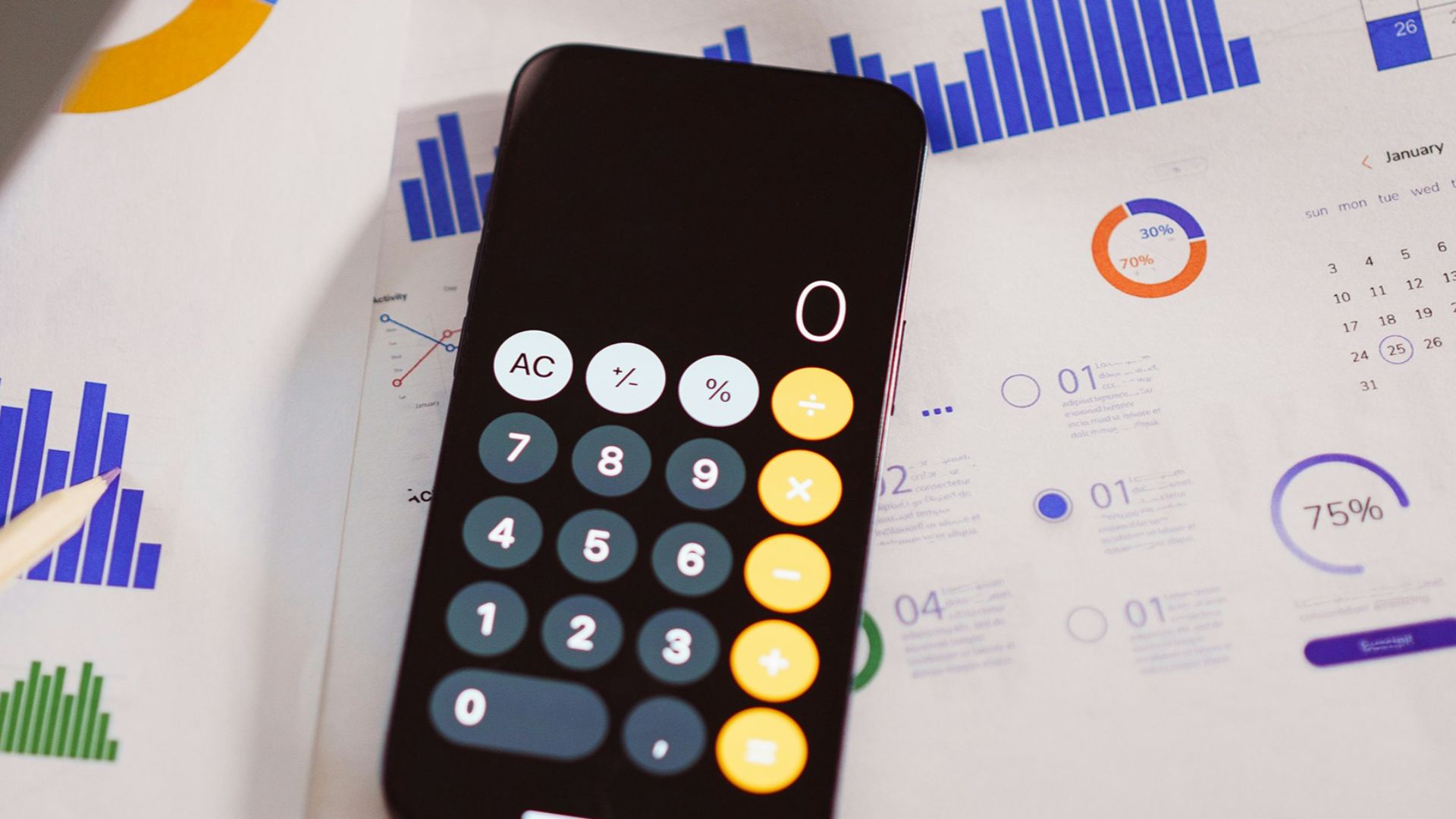 a calculator sitting on top of a table next to a laptop