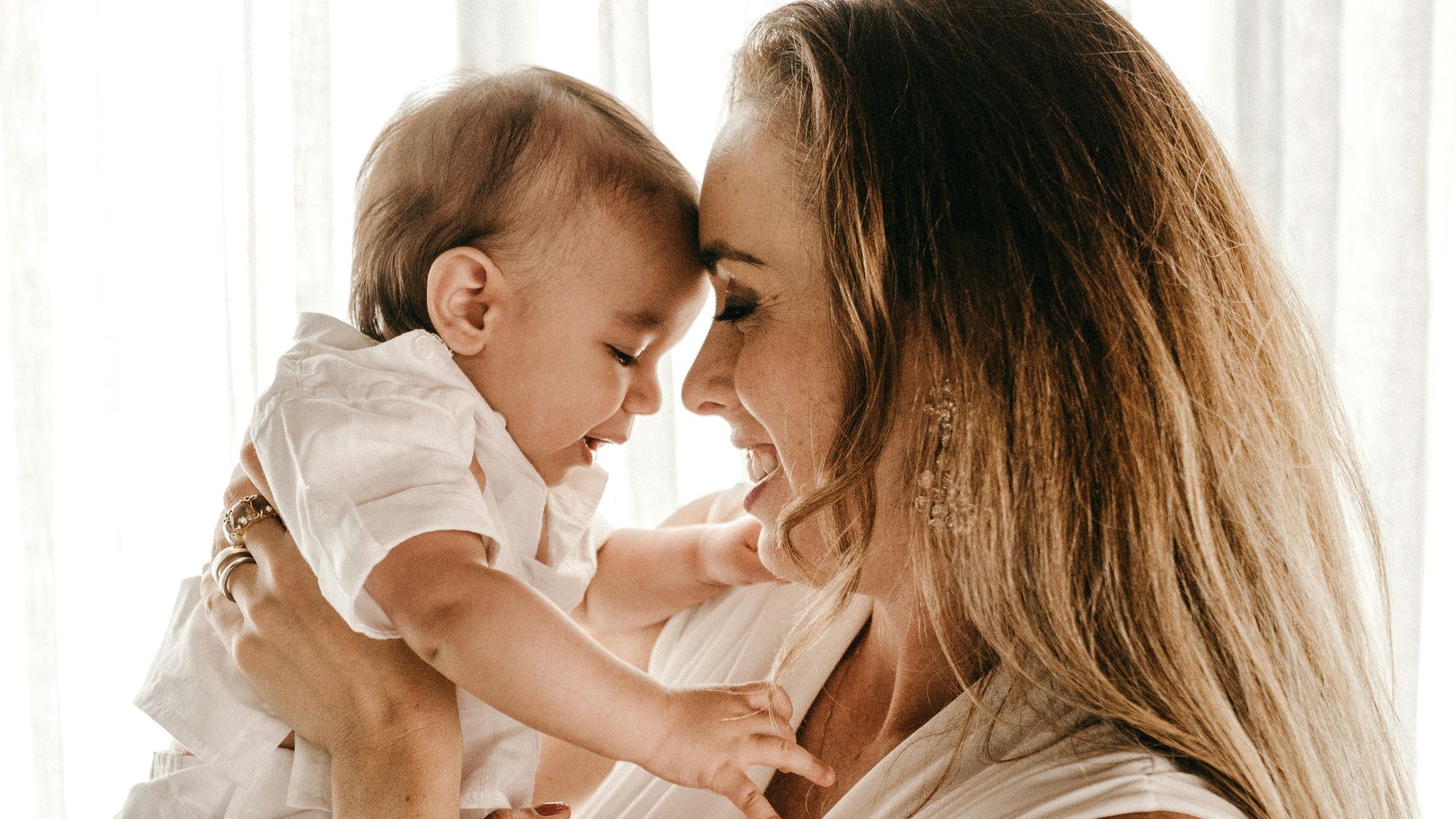 smiling woman carrying baby