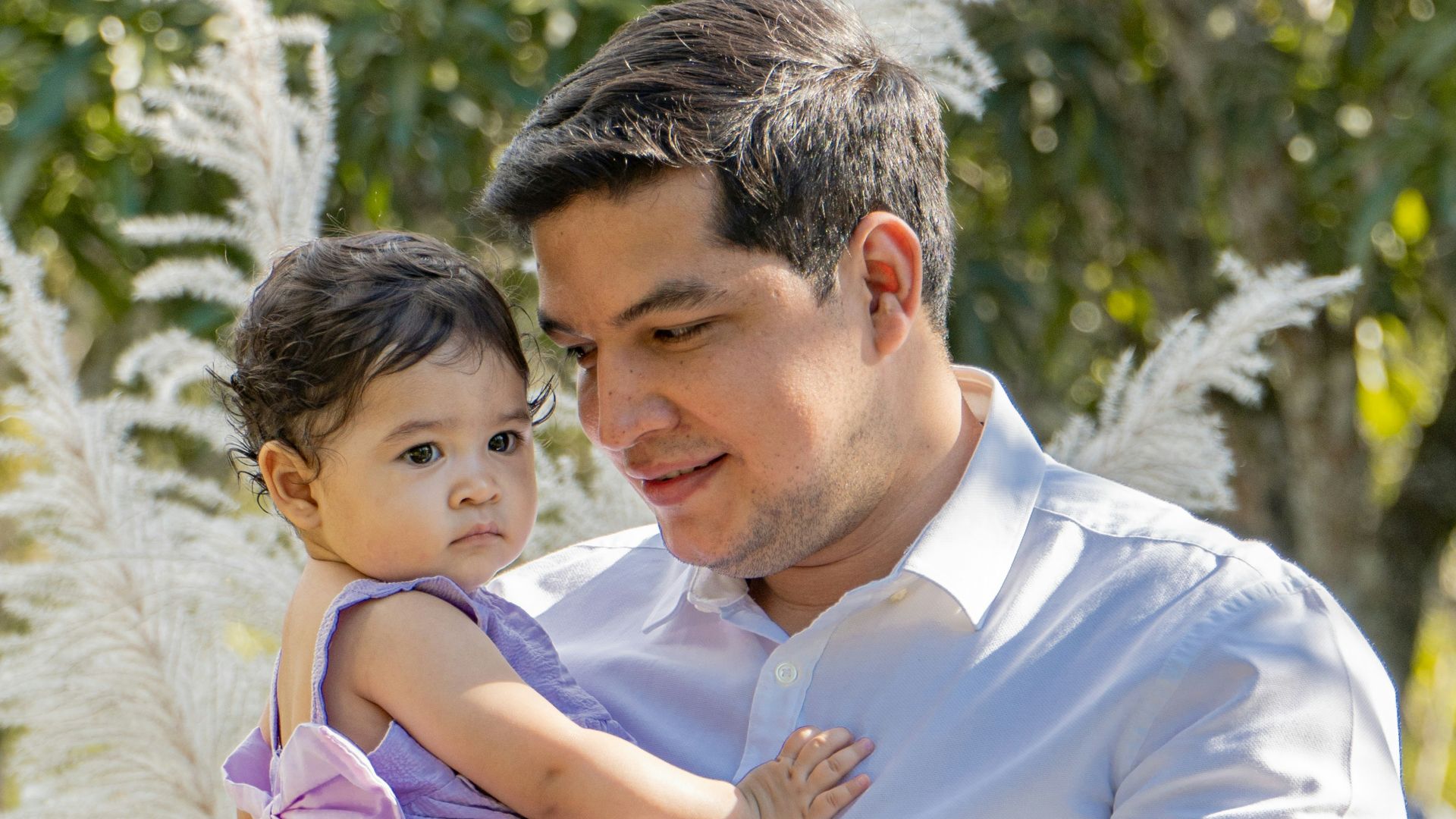 a man holding a little girl in his arms