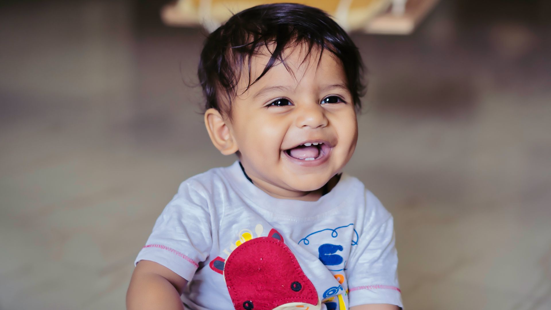 boy in blue and red crew neck t-shirt sitting on yellow and white chair