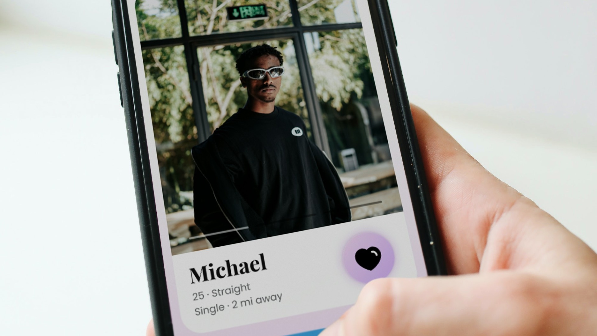 a person holding a cell phone with a picture of a man on it