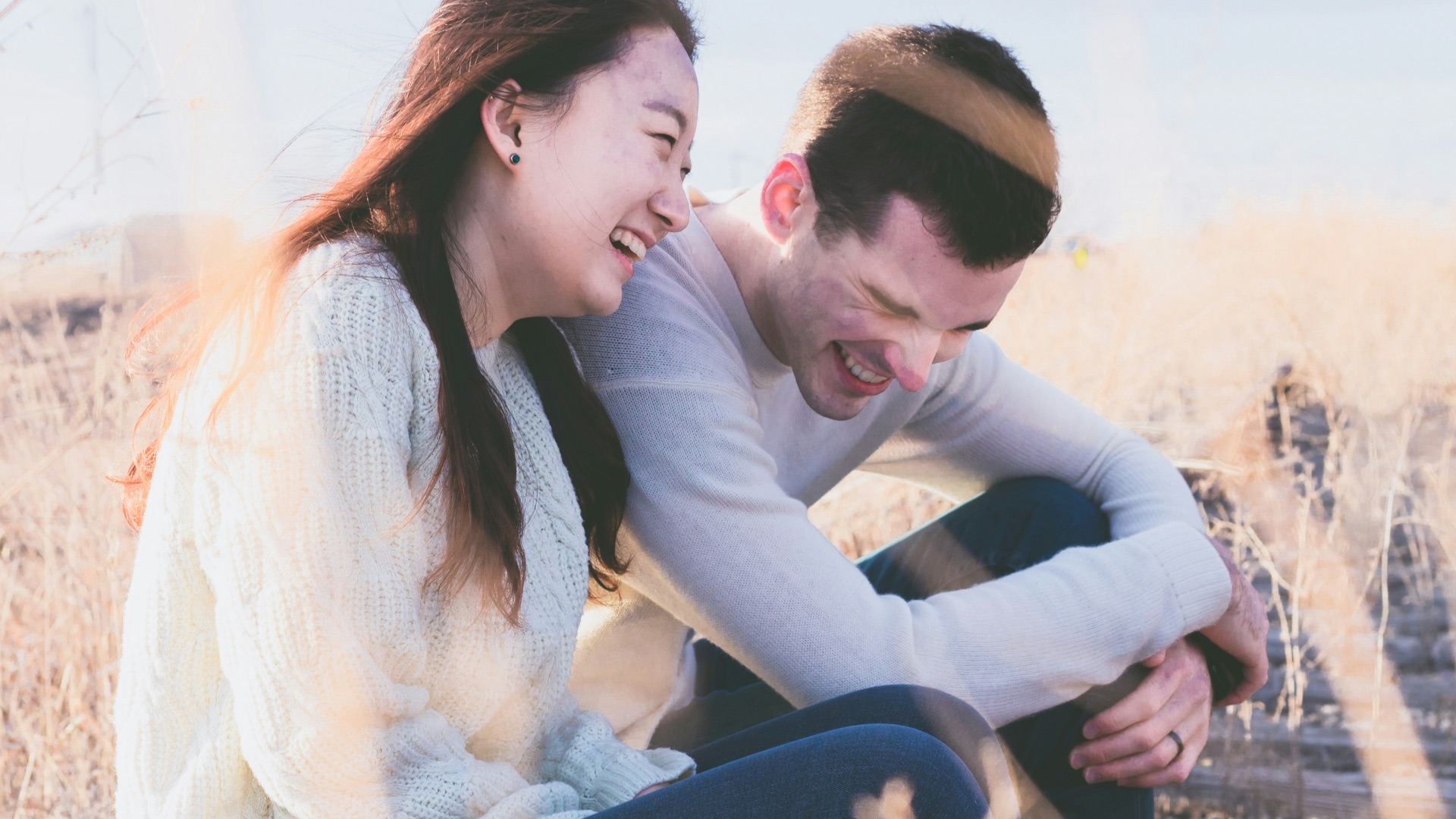 photo of man and woman laughing during daytime
