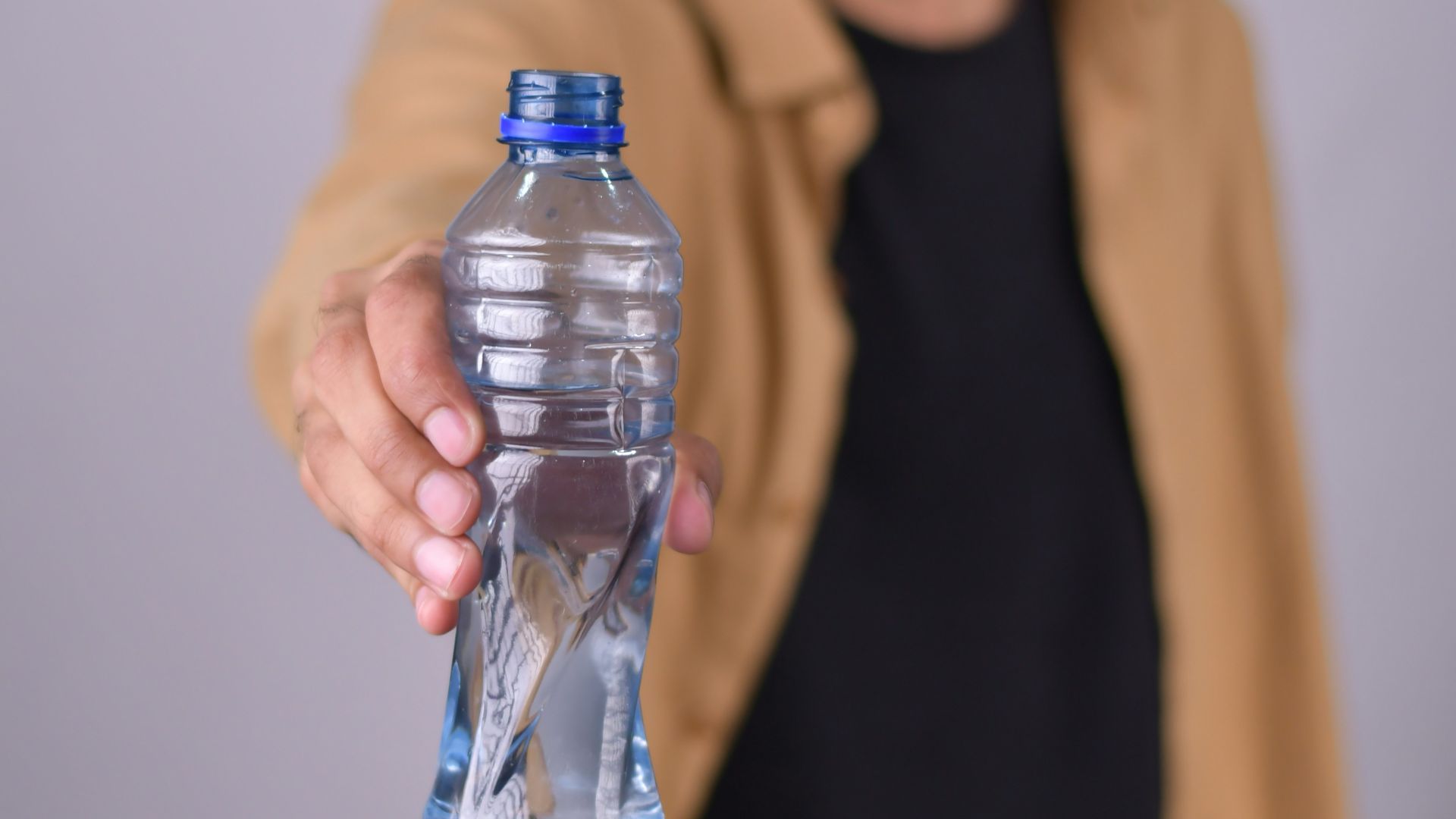 a man holding a bottle of water in his hand