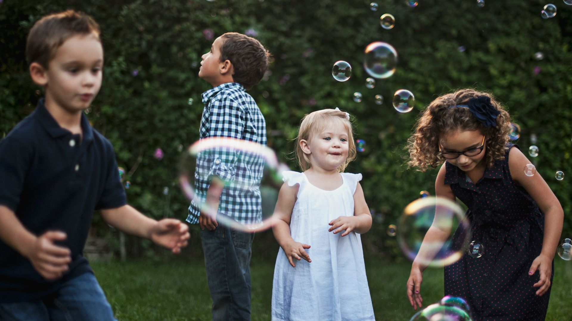 girl in white dress standing beside man in blue and white plaid dress shirt