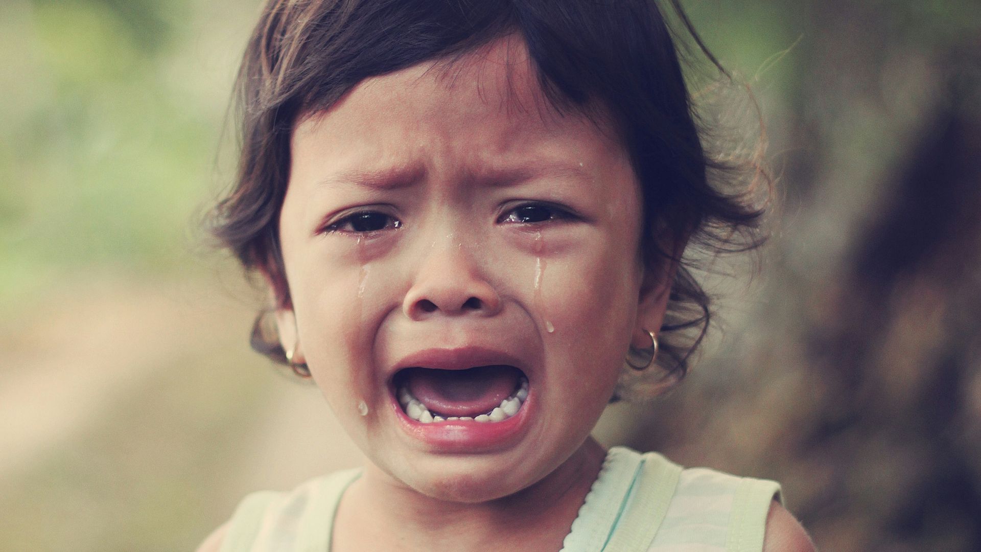 selective focus photography of girl crying