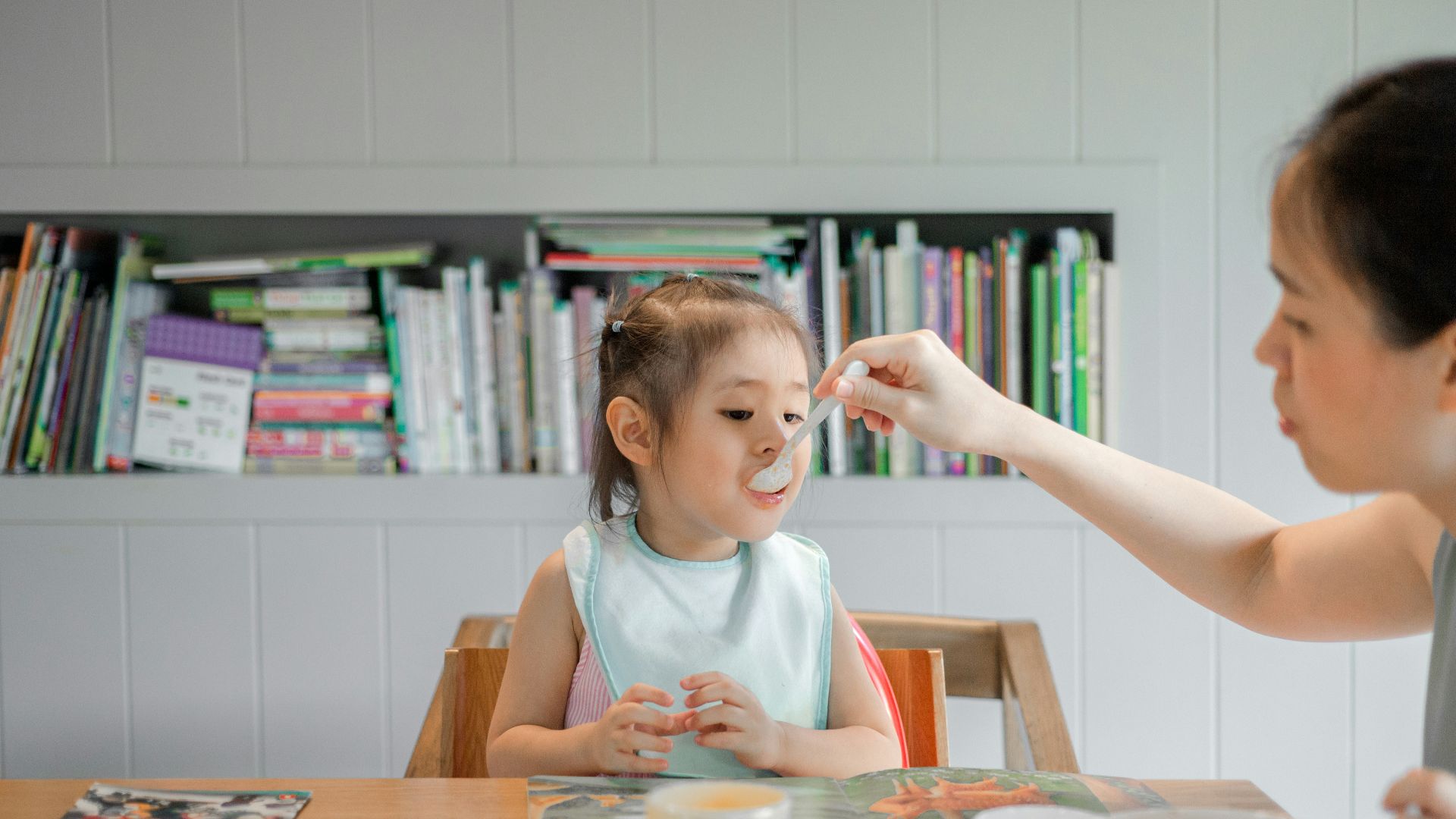 woman holding white plastic spoon