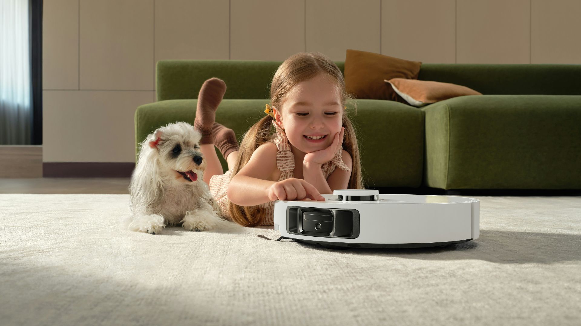 Girl and dog watch robot vacuum cleaner