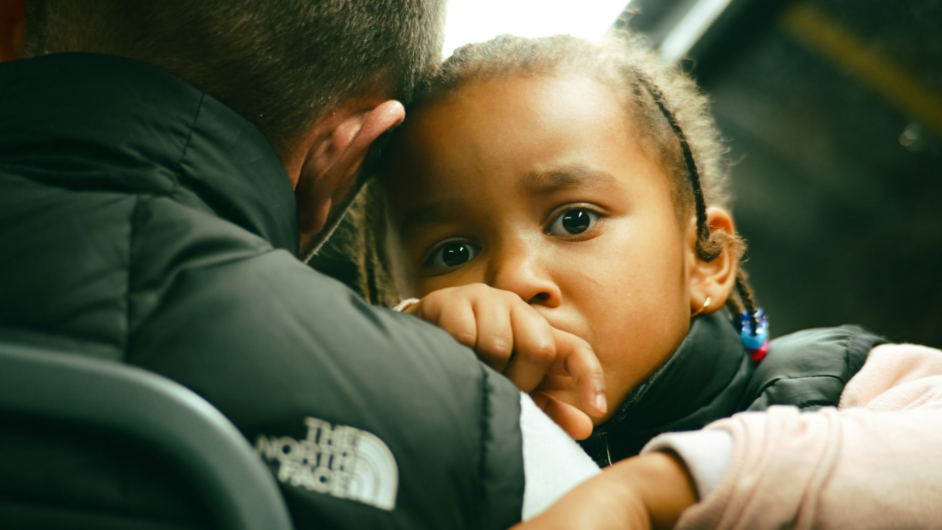 Young child looking concerned on a bus