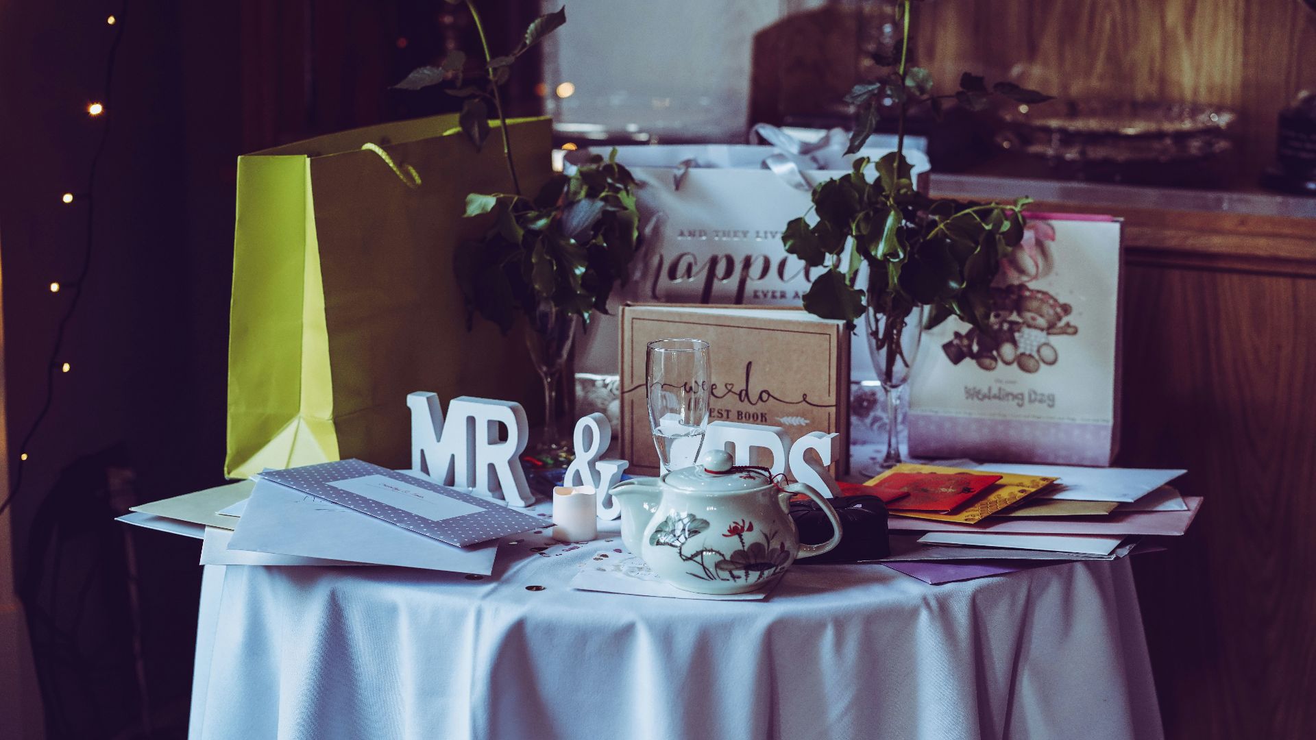 two red roses and mr. & mrs. free-standing letters on top of table