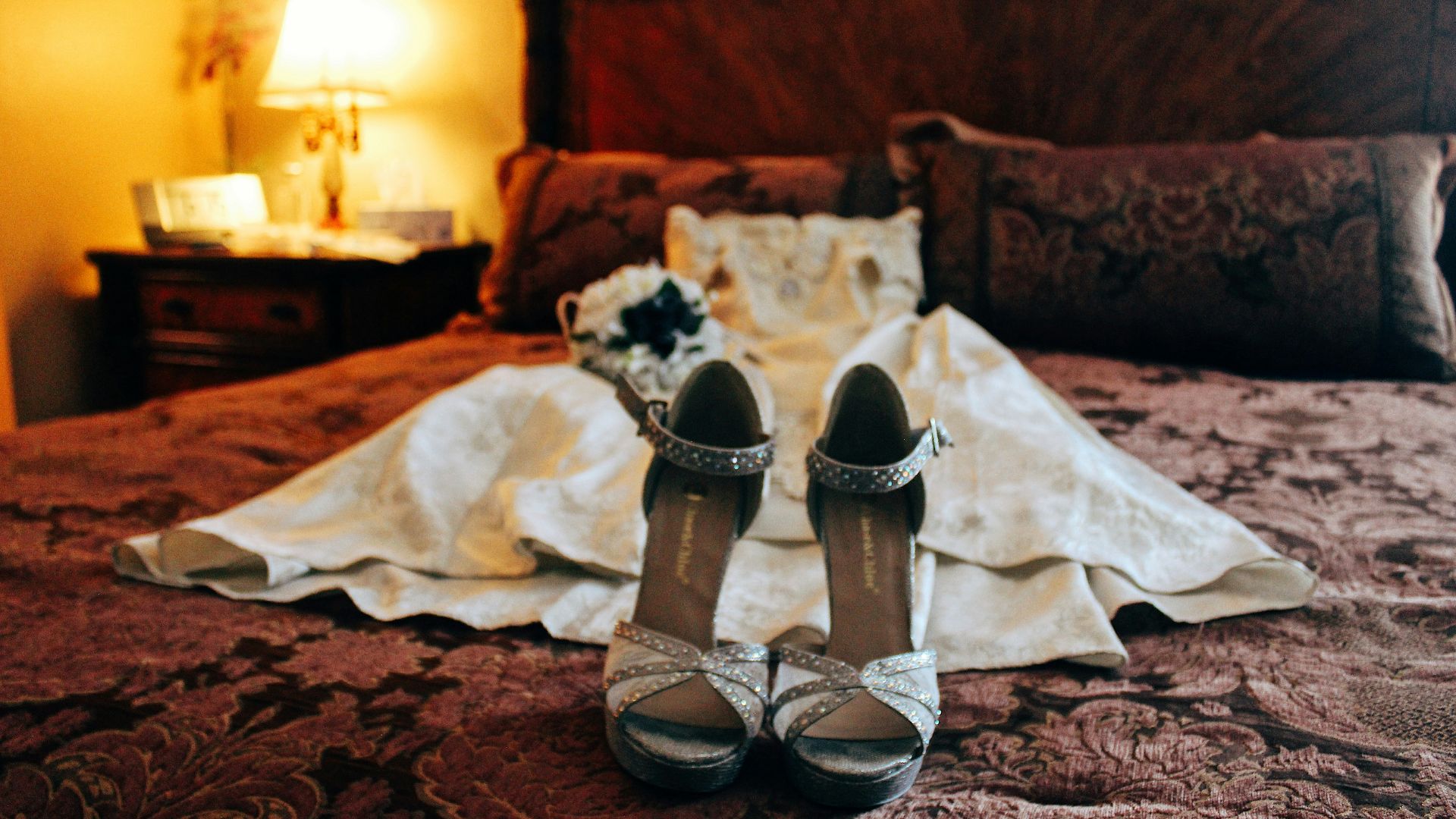 white and black open toe sandals on brown and black floral textile