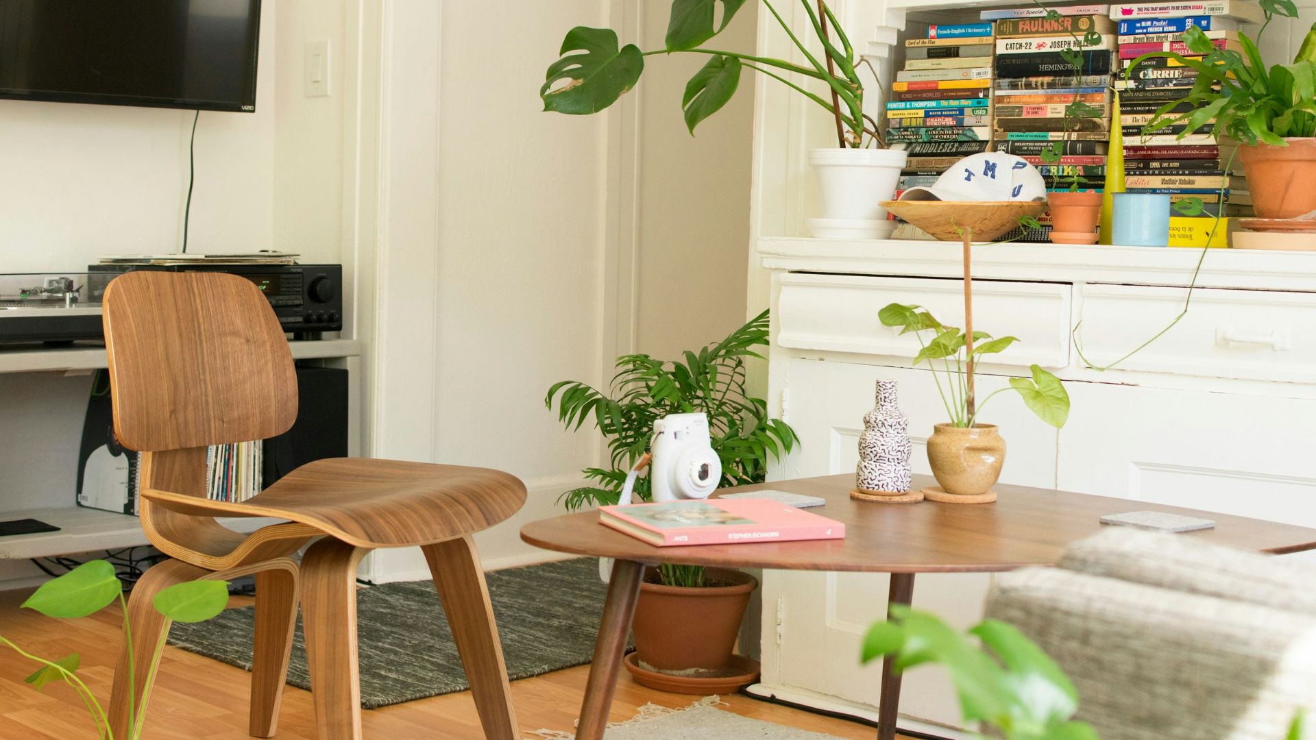 brown wooden table and chair beside bookshelf