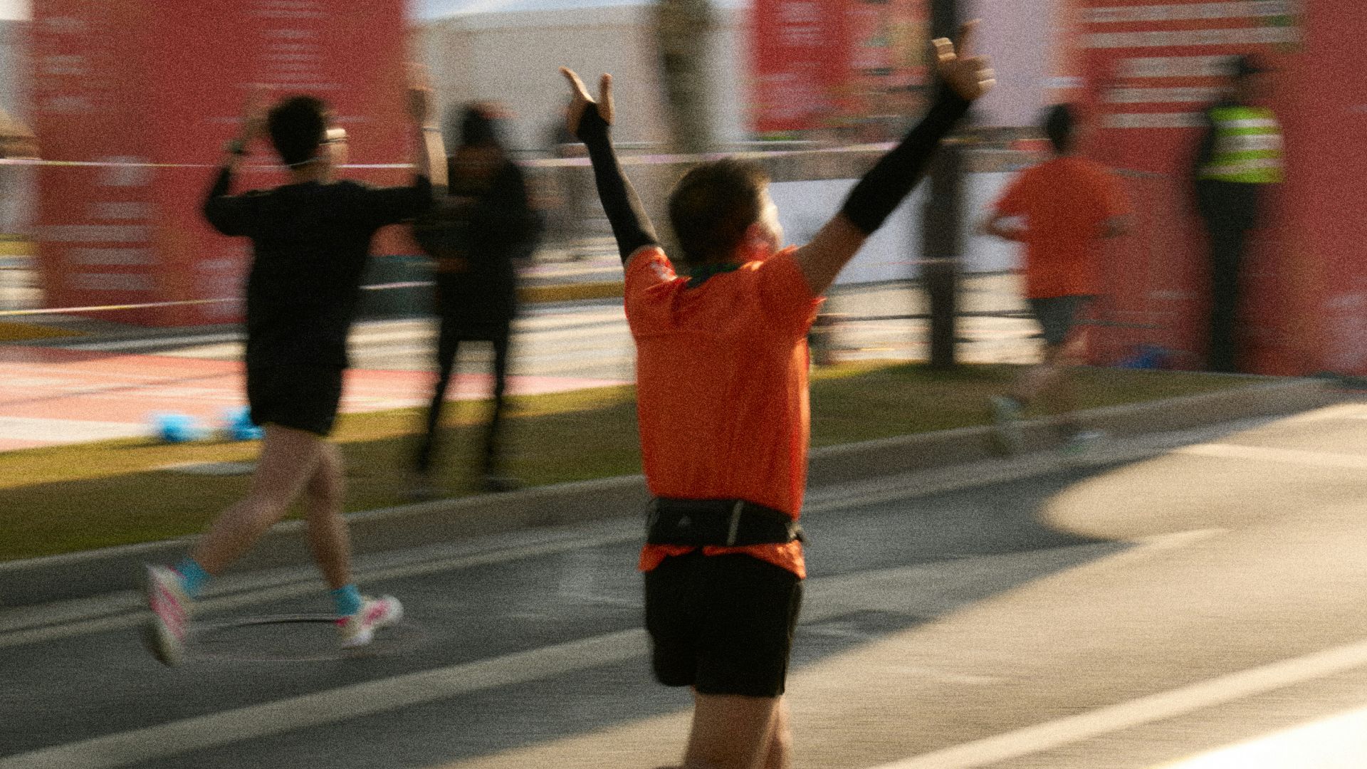 Runner celebrating crossing the finish line at a marathon.