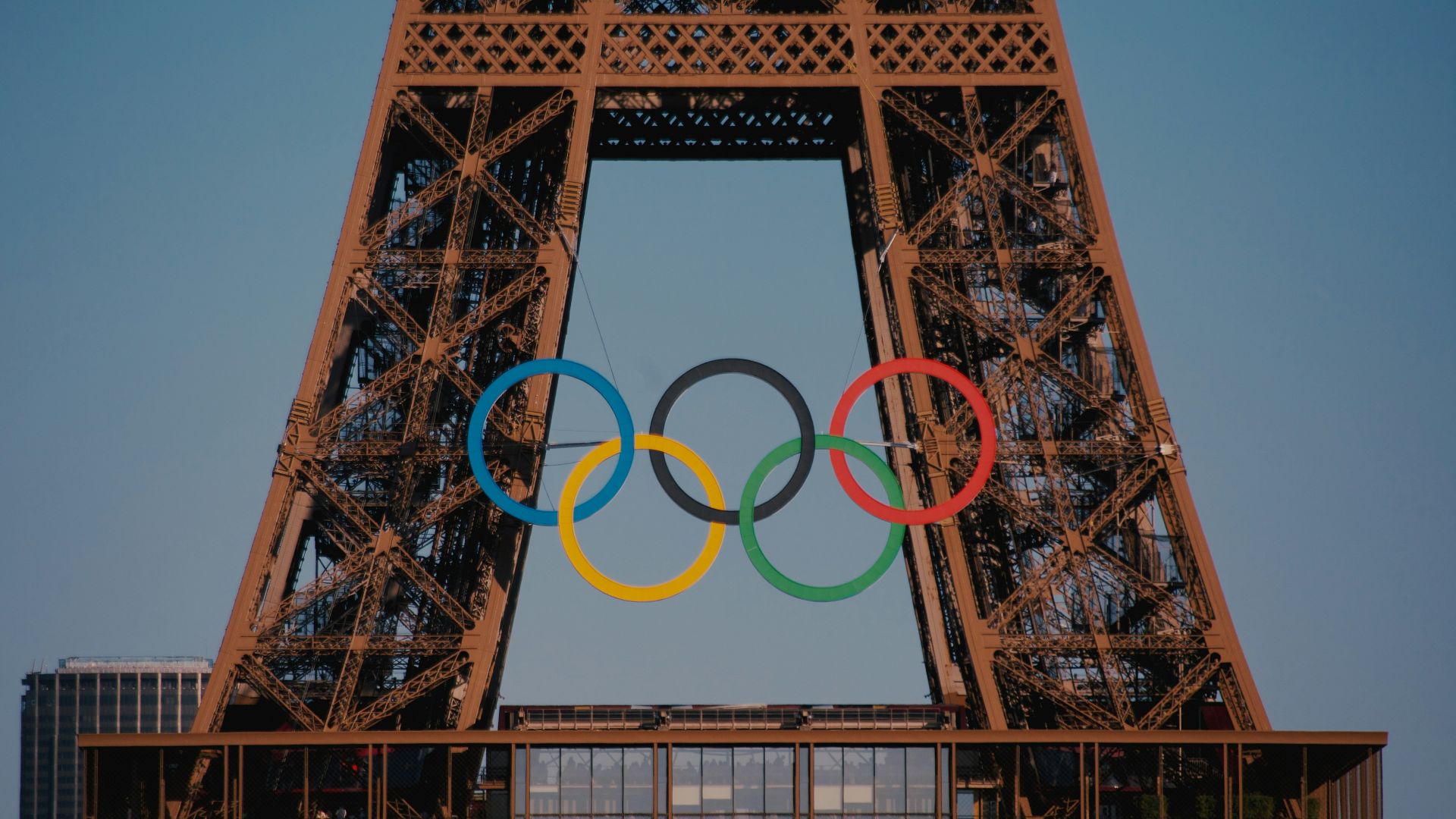 The eiffel tower with the olympic rings in front of it
