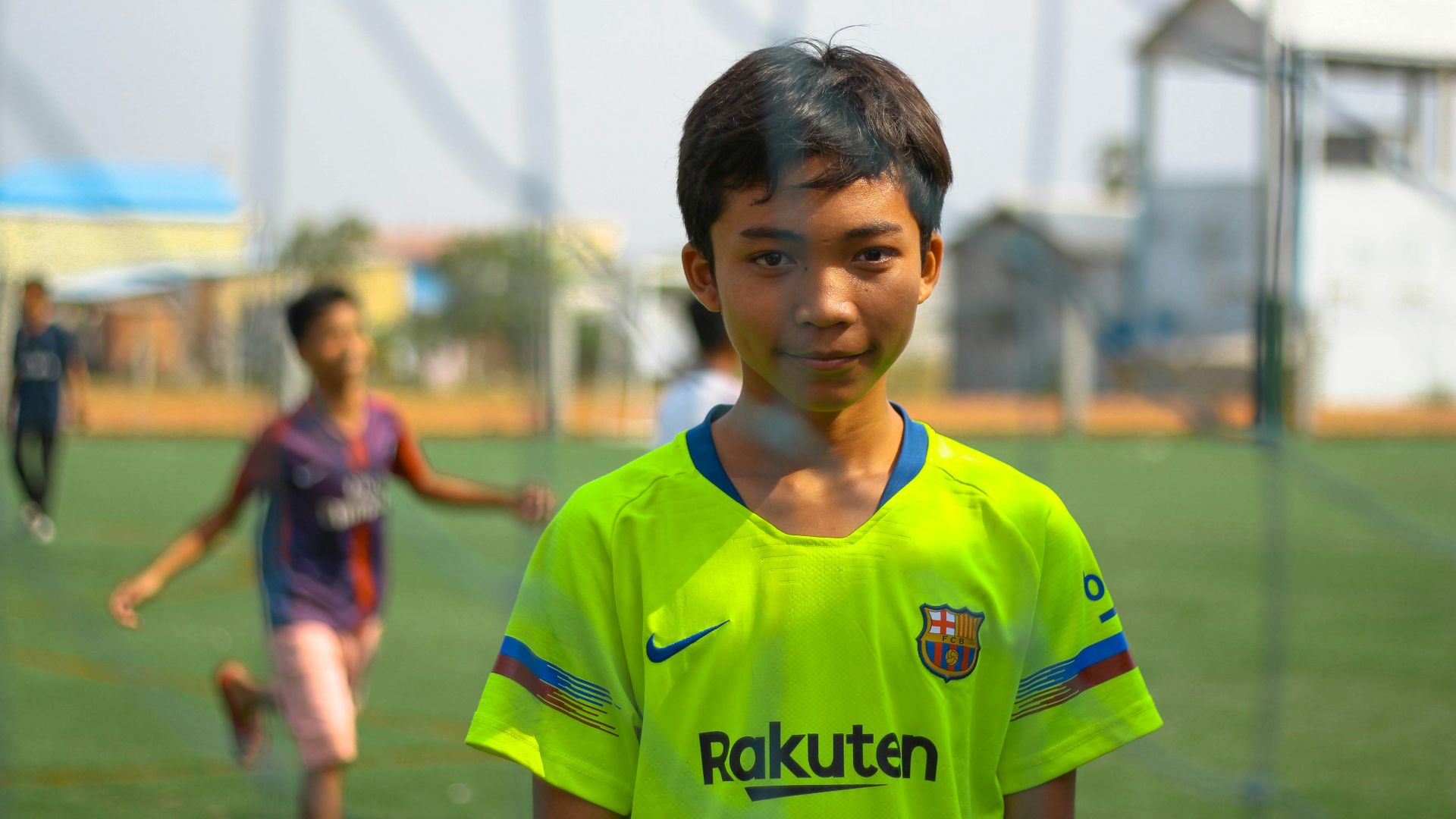 boy standing near net goal