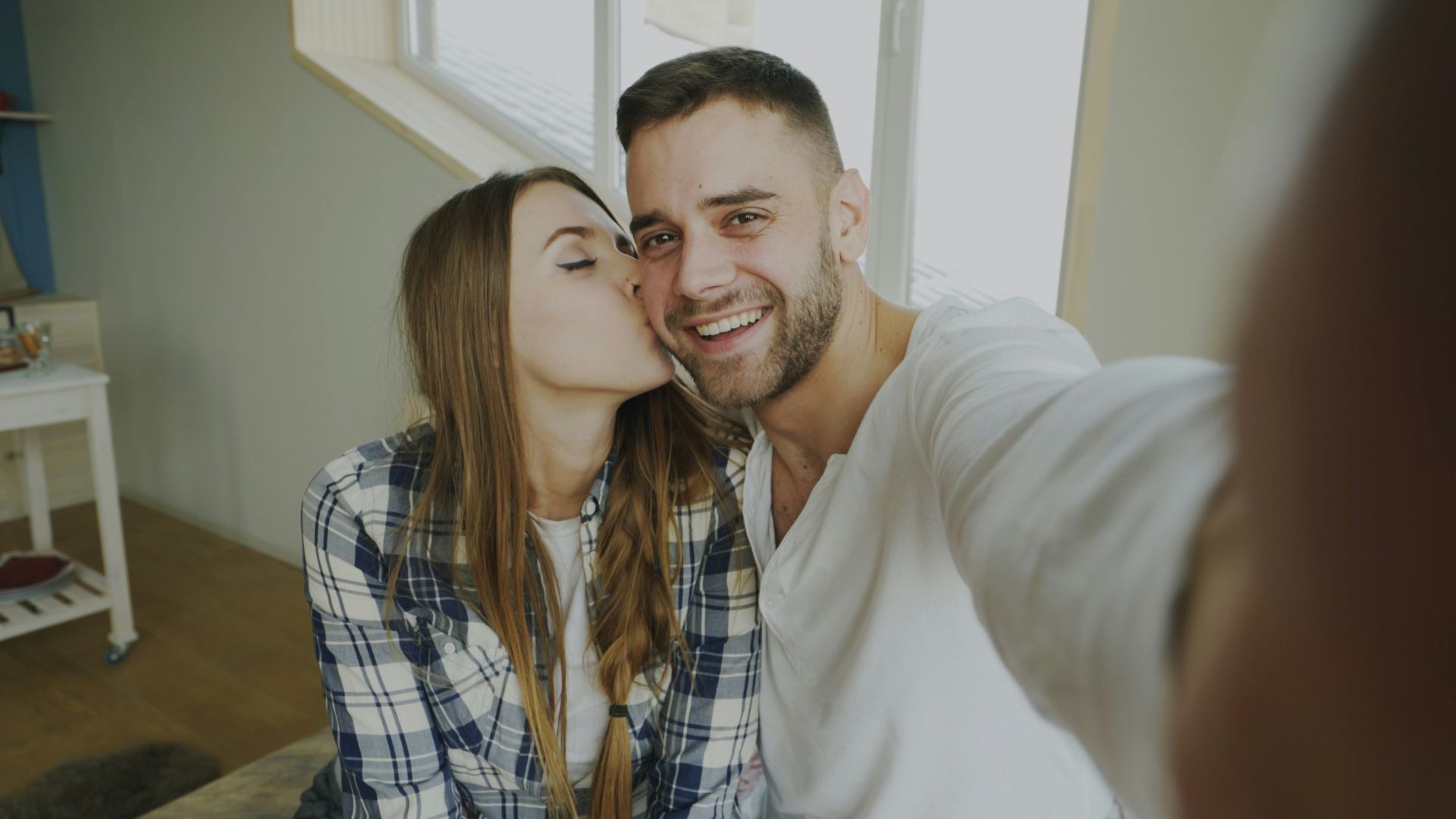 Couple taking a selfie with a kiss
