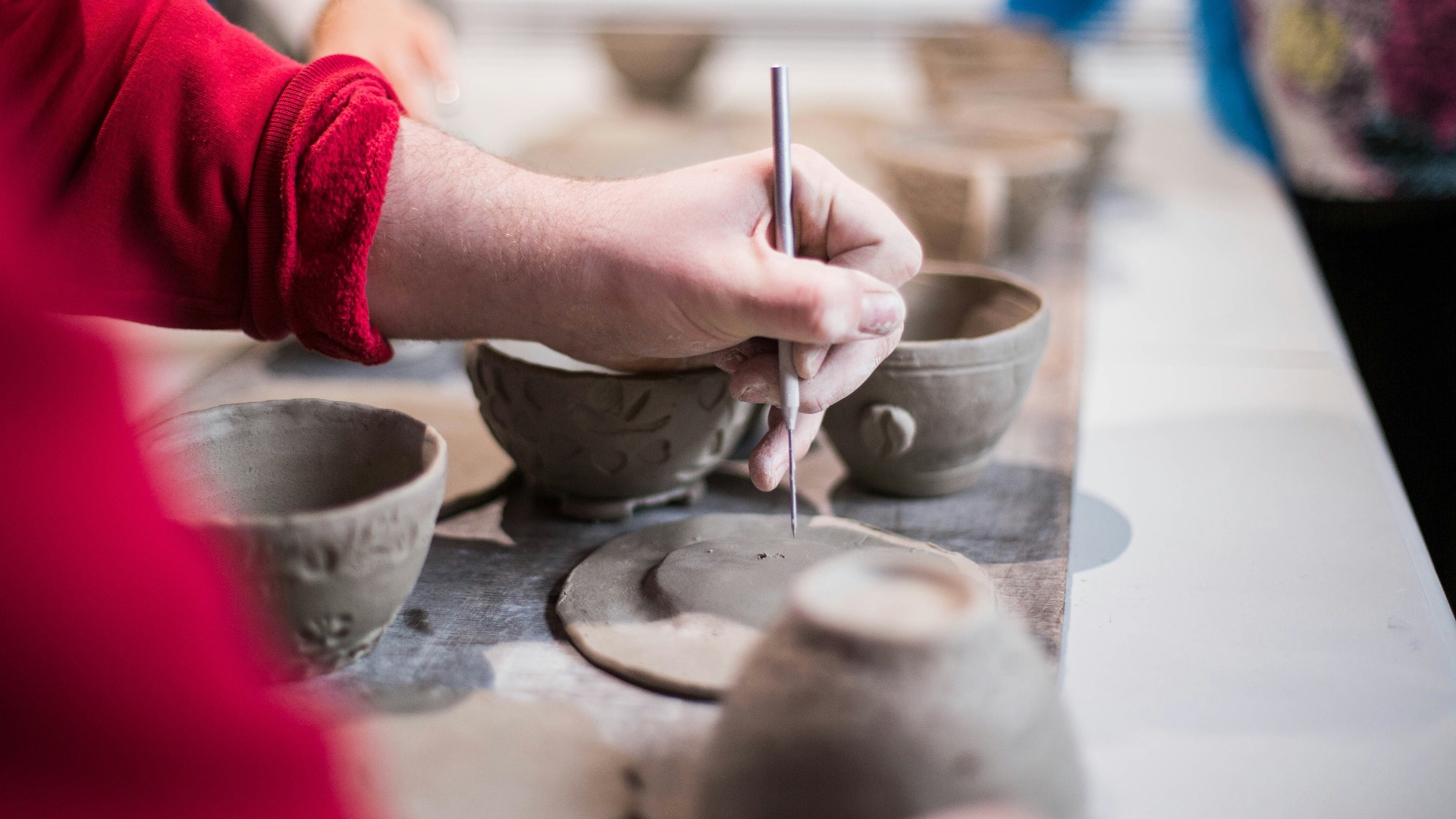 person doing clay containers