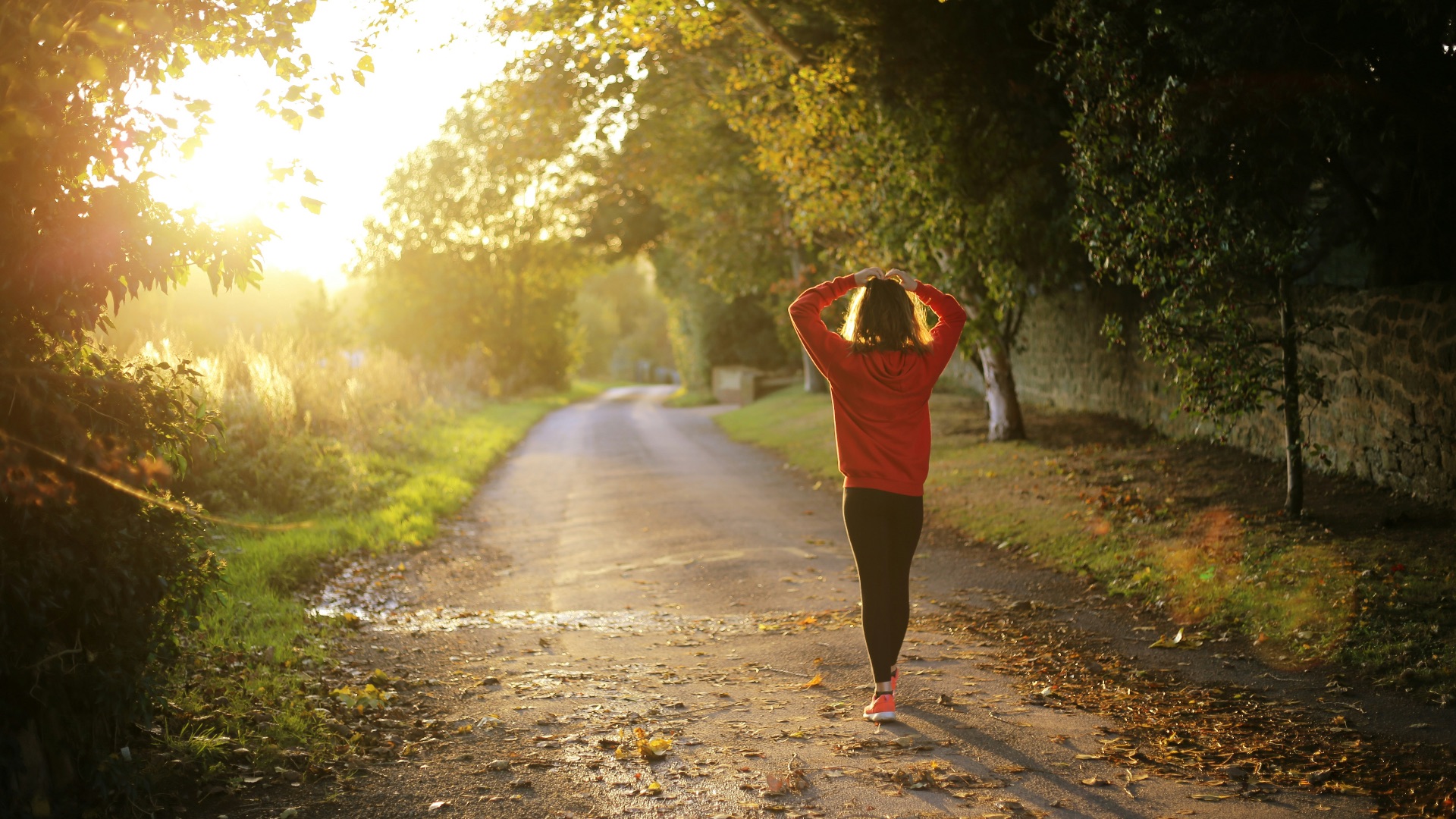 woman walking on pathway during daytime