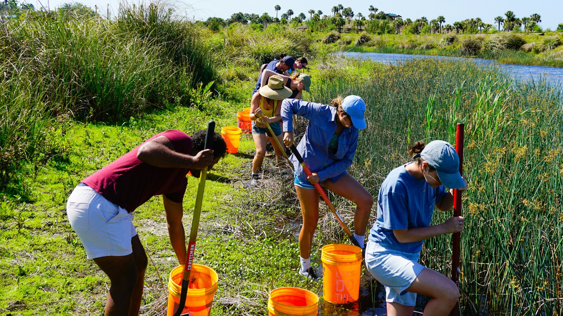 a group of people standing next to a river