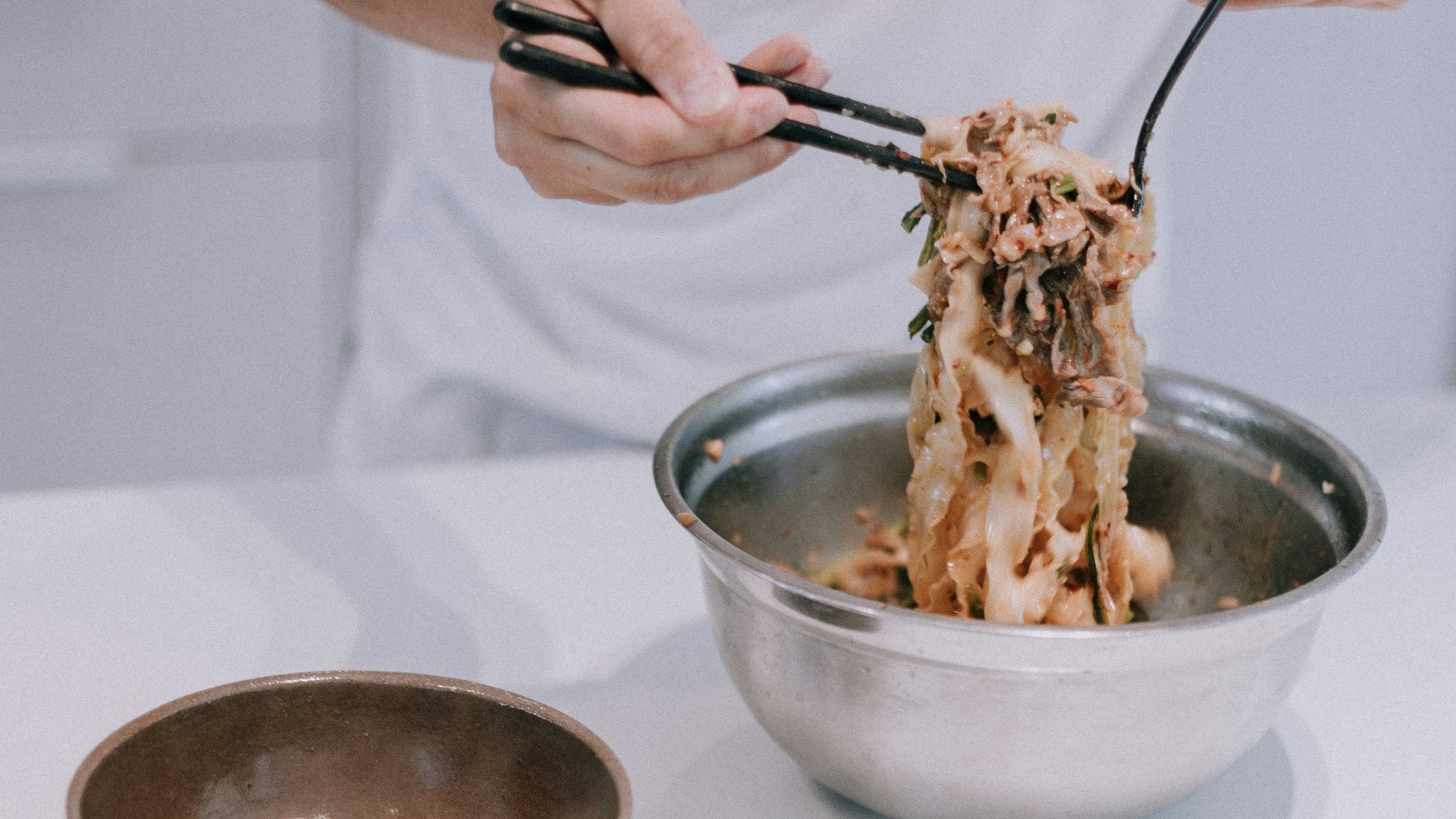person holding stainless steel spoon and fork