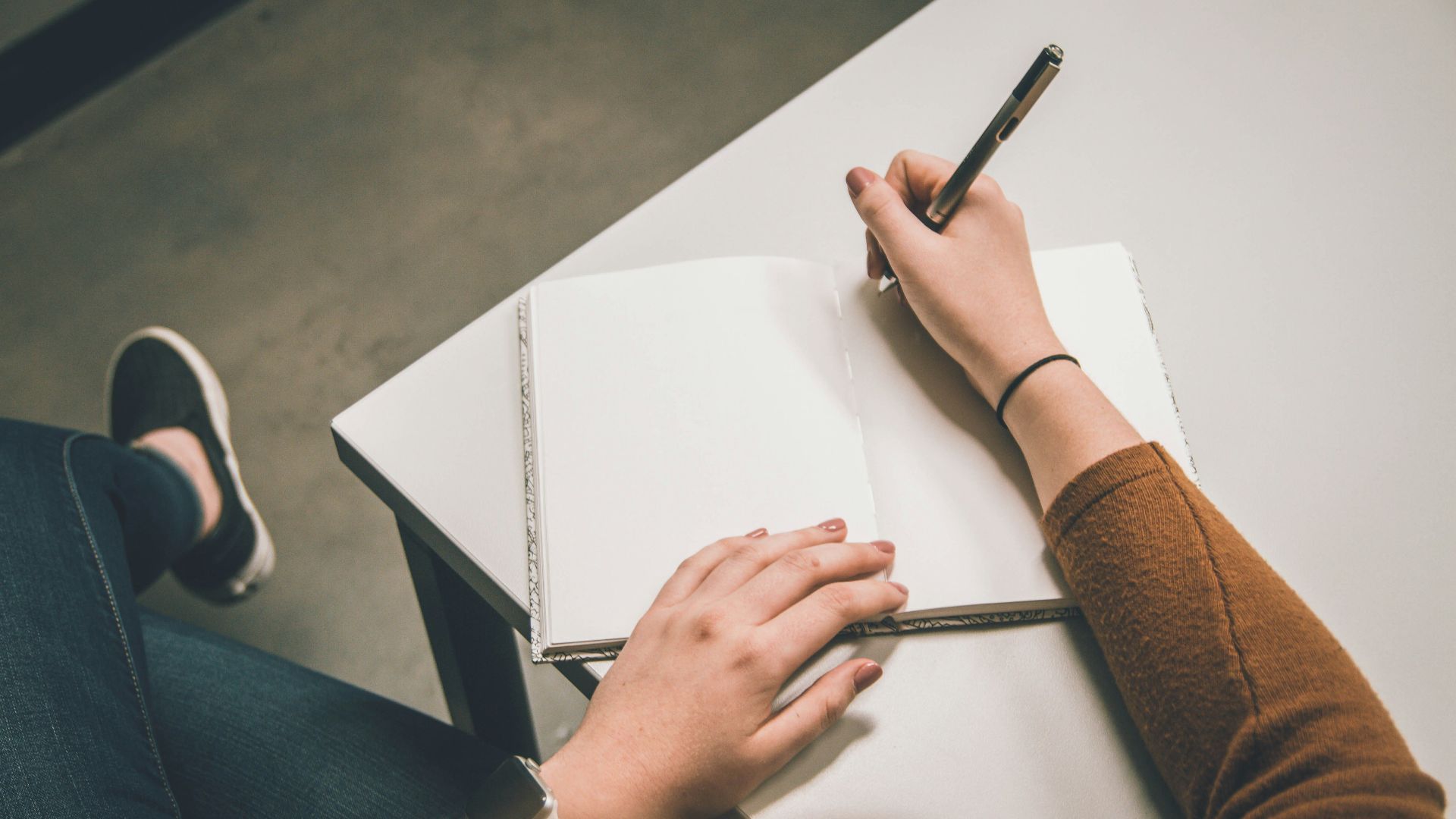 person writing on white paper