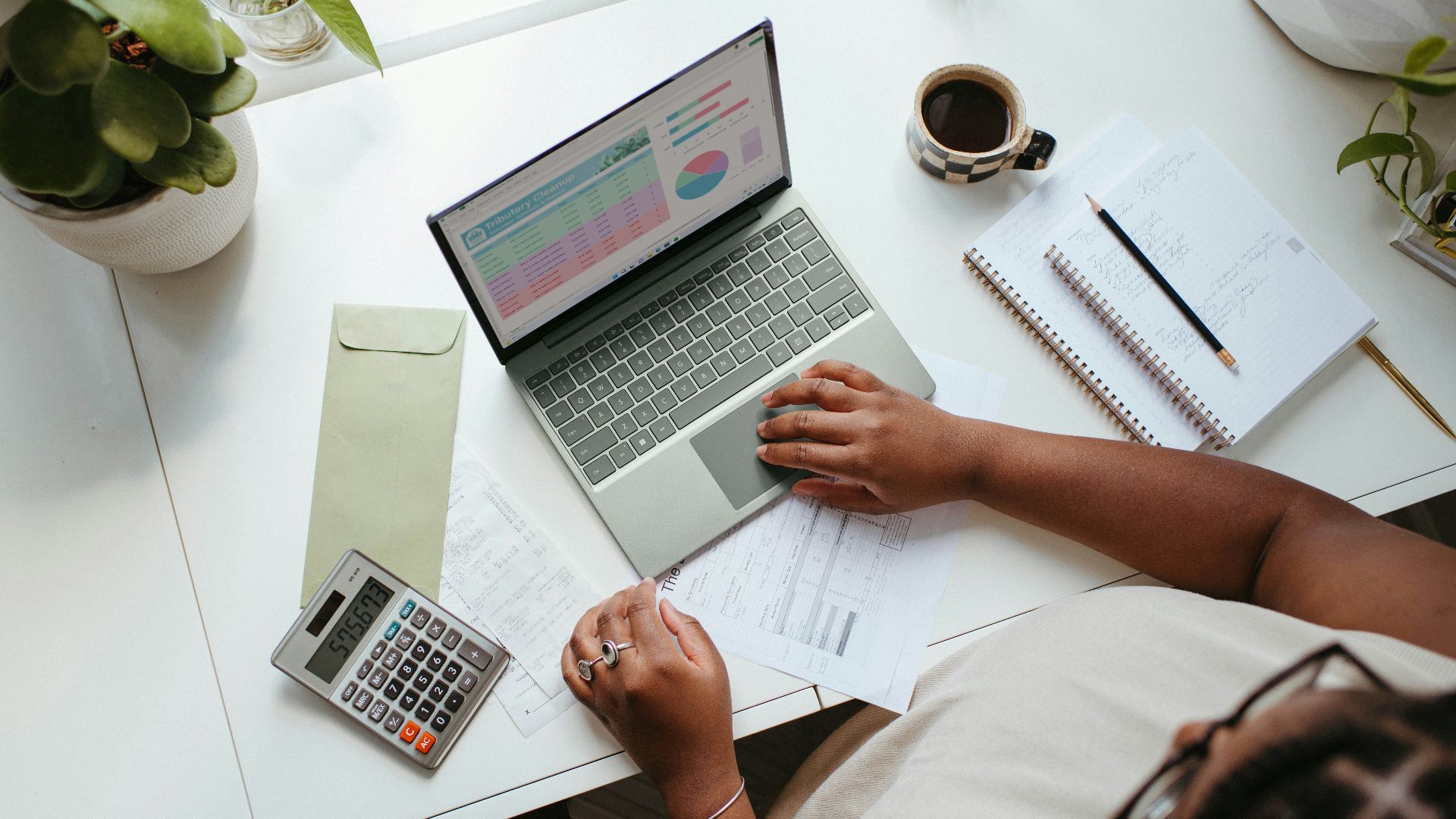 a person sitting at a table with a laptop